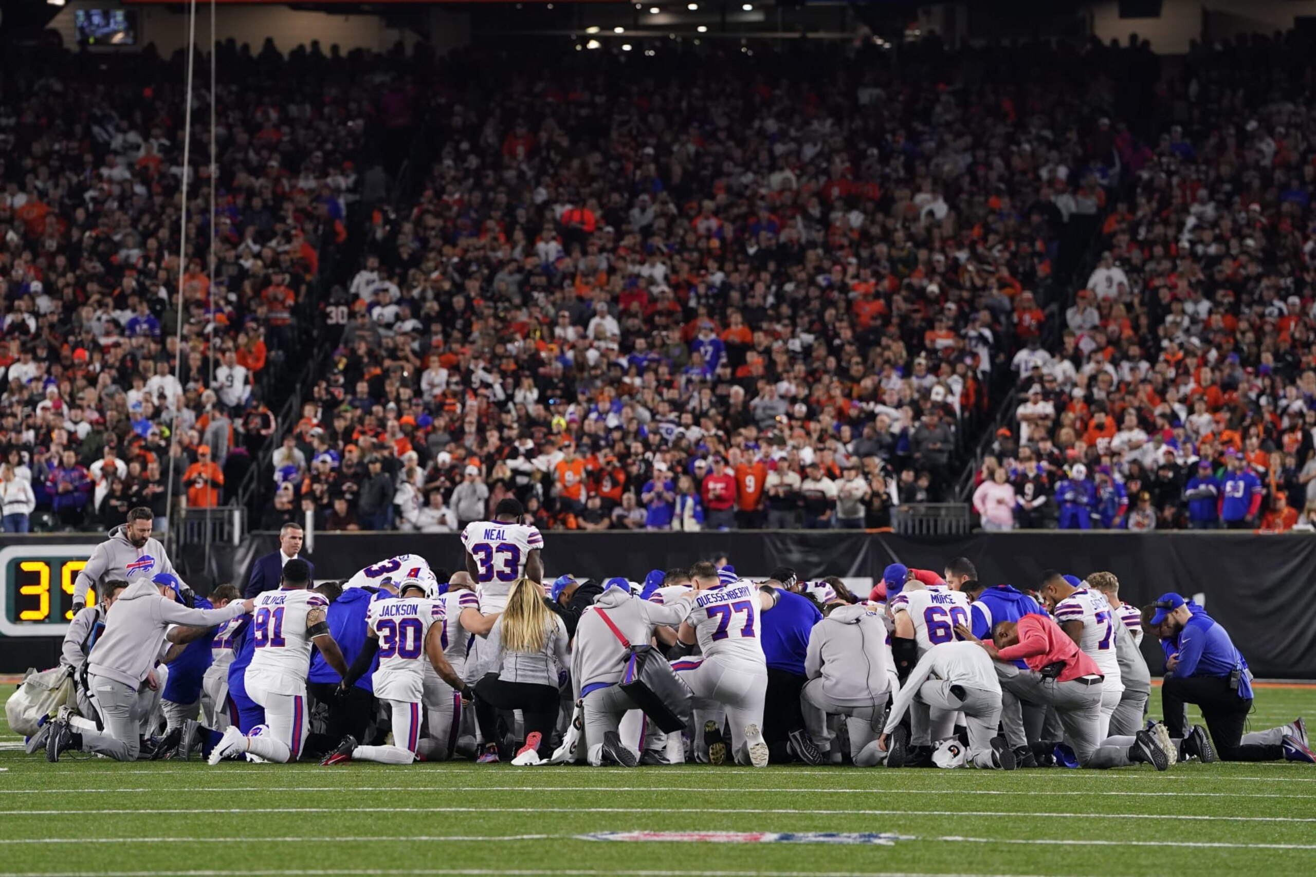 CINCINNATI, OHIO - JANUARY 02: Buffalo Bills players huddle and pray after teammate Damar Hamlin #3 collapsed on the field after making a tackle against the Cincinnati Bengals during the first quarter at Paycor Stadium on January 02, 2023 in Cincinnati, Ohio. (Photo by Dylan Buell/Getty Images)