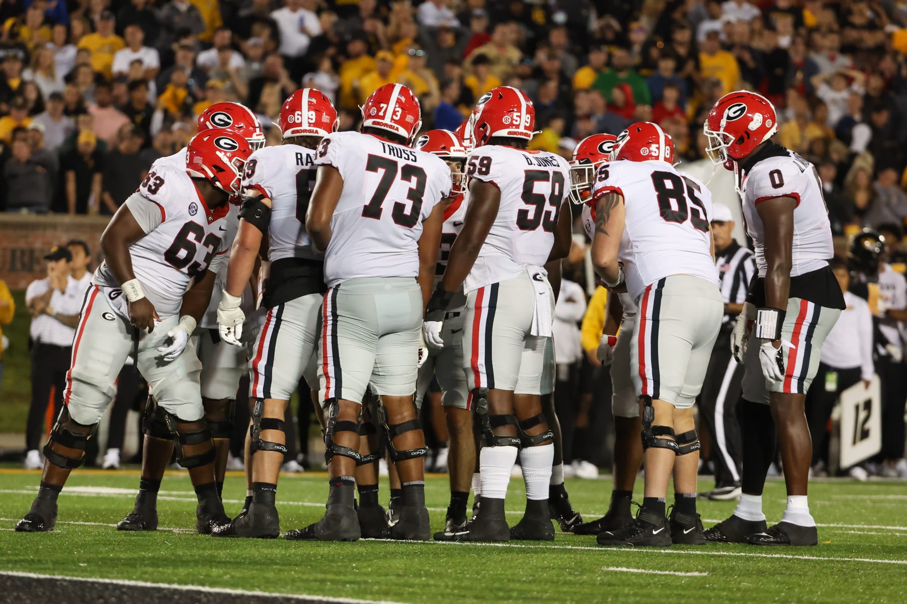 Georgia Bulldogs offense huddles near the goal line. 