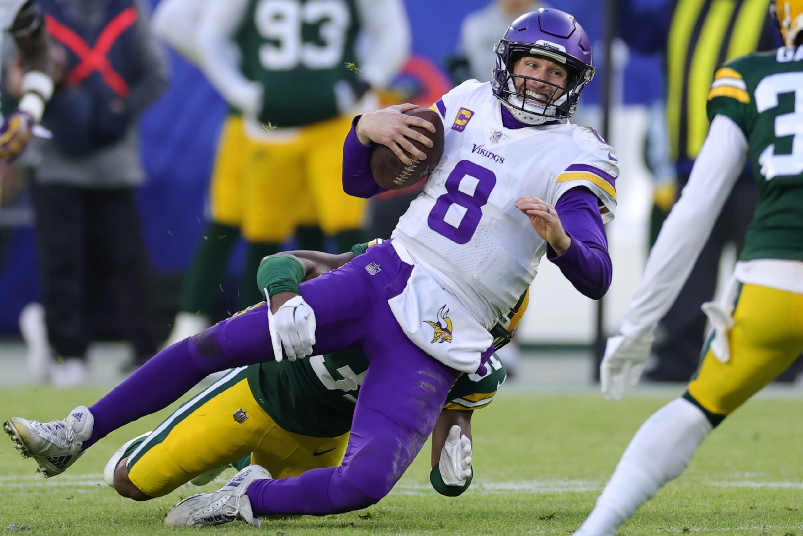 GREEN BAY, WISCONSIN - JANUARY 01: Kirk Cousins #8 of the Minnesota Vikings is tackled Adrian Amos #31 of the Green Bay Packers during the first quarter by at Lambeau Field on January 01, 2023 in Green Bay, Wisconsin. (Photo by Stacy Revere/Getty Images)