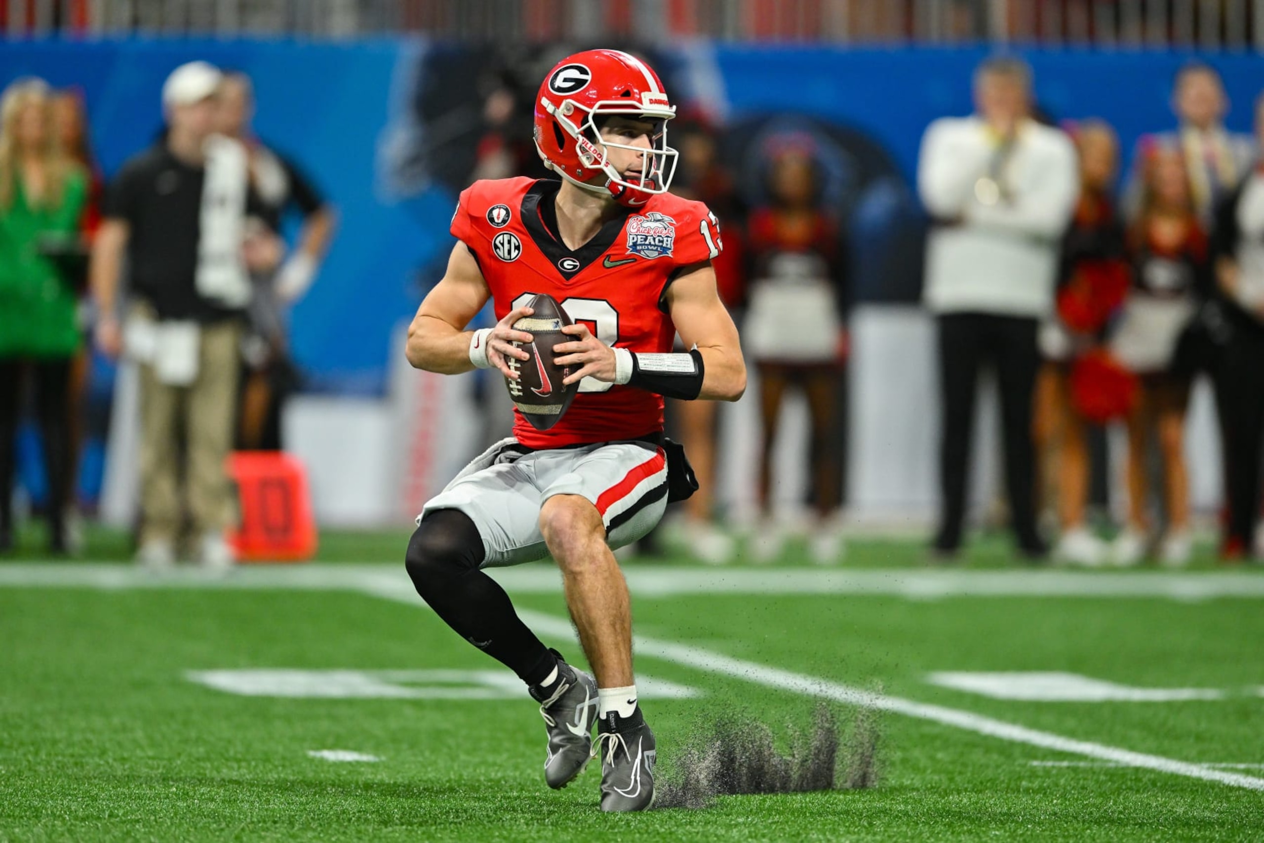 ATLANTA, GA  DECEMBER 31:  Georgia quarterback Stetson Bennett (13) drops back to pass during the Chick-fil-A Peach Bowl semifinal college football playoff between the Ohio State Buckeyes and the Georgia Bulldogs on December 31st, 2022 at Mercedes-Benz Stadium in Atlanta, GA.  (Photo by Rich von Biberstein/Icon Sportswire via Getty Images)
