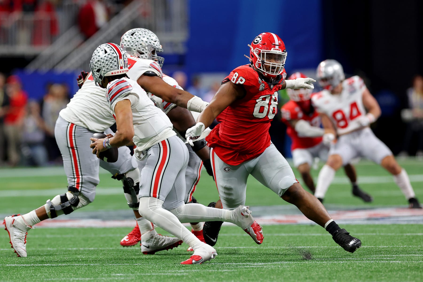 ATLANTA, GEORGIA - DECEMBER 31: Jalen Carter #88 of the Georgia Bulldogs pursues C.J. Stroud #7 of the Ohio State Buckeyes during the third quarter in the Chick-fil-A Peach Bowl at Mercedes-Benz Stadium on December 31, 2022 in Atlanta, Georgia. (Photo by Kevin C. Cox/Getty Images)