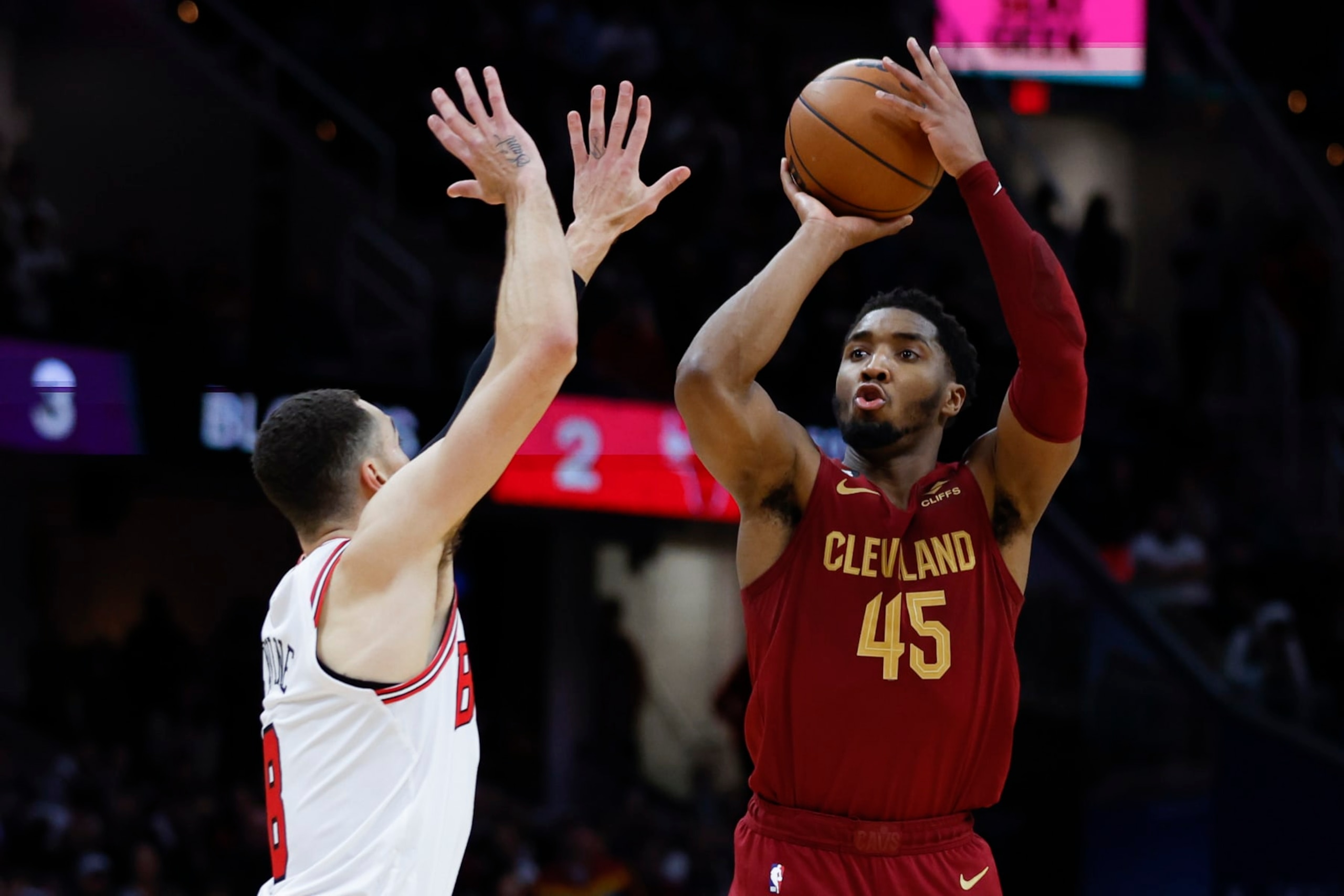 Cleveland Cavaliers guard Donovan Mitchell (45) shoots against Chicago Bulls guard Zach LaVine (8) during the second half of an NBA basketball game, Monday, Jan. 2, 2023, in Cleveland. (AP Photo/Ron Schwane)