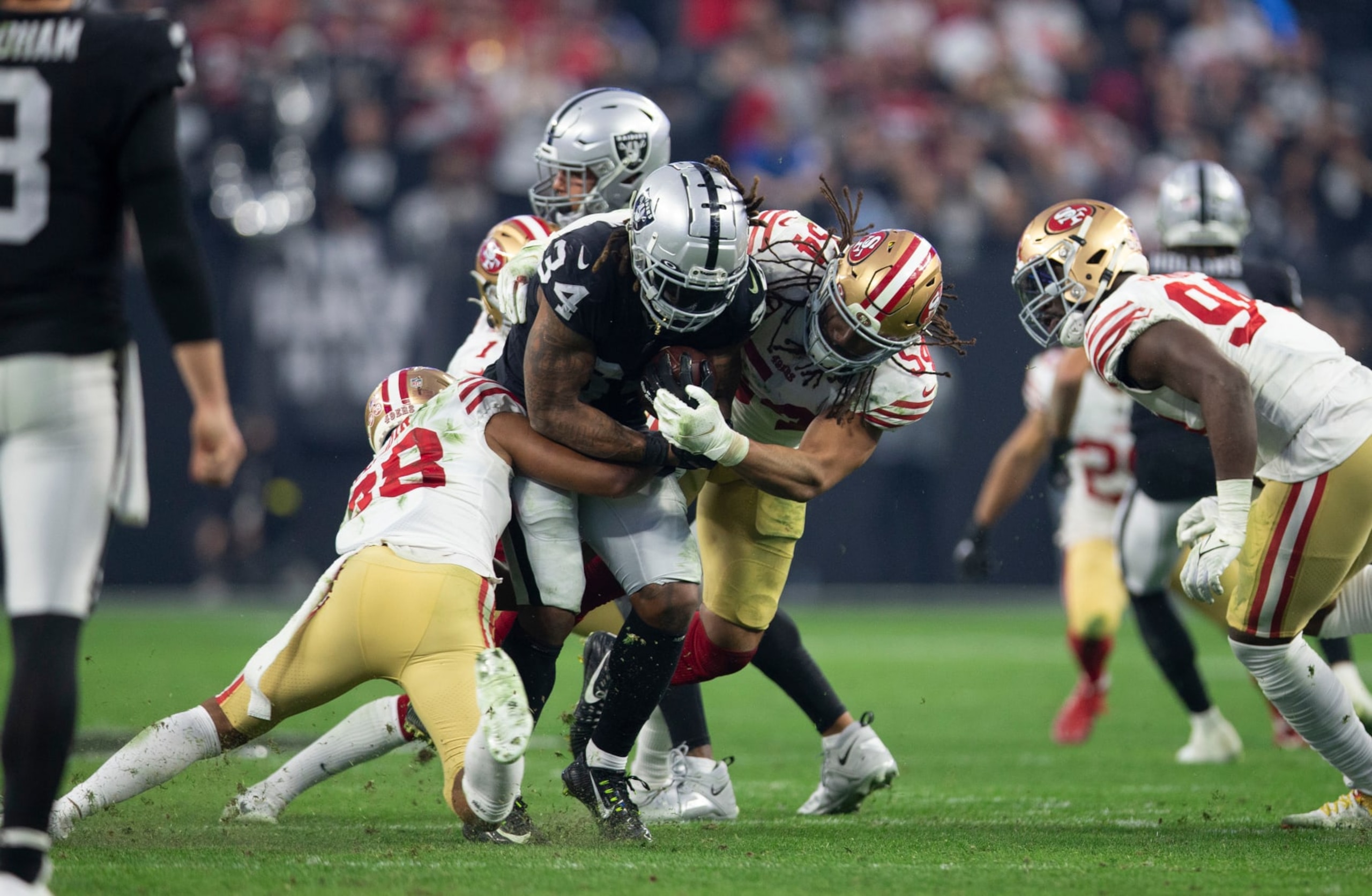 LAS VEGAS, NV - JANUARY 1: Deommodore Lenoir #38 and Fred Warner #54 of the San Francisco 49ers make a tackle during the game against the Las Vegas Raiders at Allegiant Stadium on January 1, 2023 in Las Vegas, Nevada. The 49ers defeated the Raiders 37-34. (Photo by Michael Zagaris/San Francisco 49ers/Getty Images)