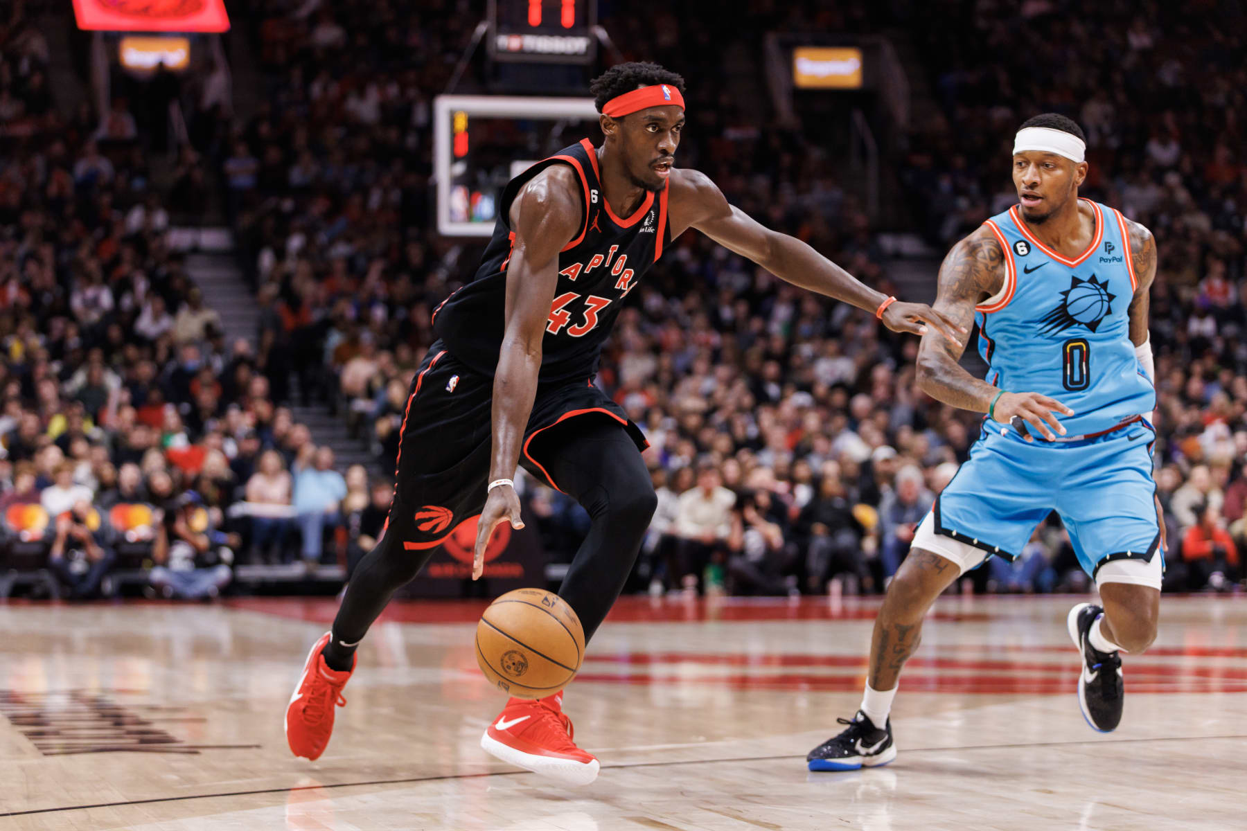 TORONTO, ON - DECEMBER 30: Pascal Siakam #43 of the Toronto Raptors drives to the net against Torrey Craig #0 of the Phoenix Suns during the first half of their NBA game at Scotiabank Arena on December 30, 2022 in Toronto, Canada. NOTE TO USER: User expressly acknowledges and agrees that, by downloading and or using this photograph, User is consenting to the terms and conditions of the Getty Images License Agreement. (Photo by Cole Burston/Getty Images)