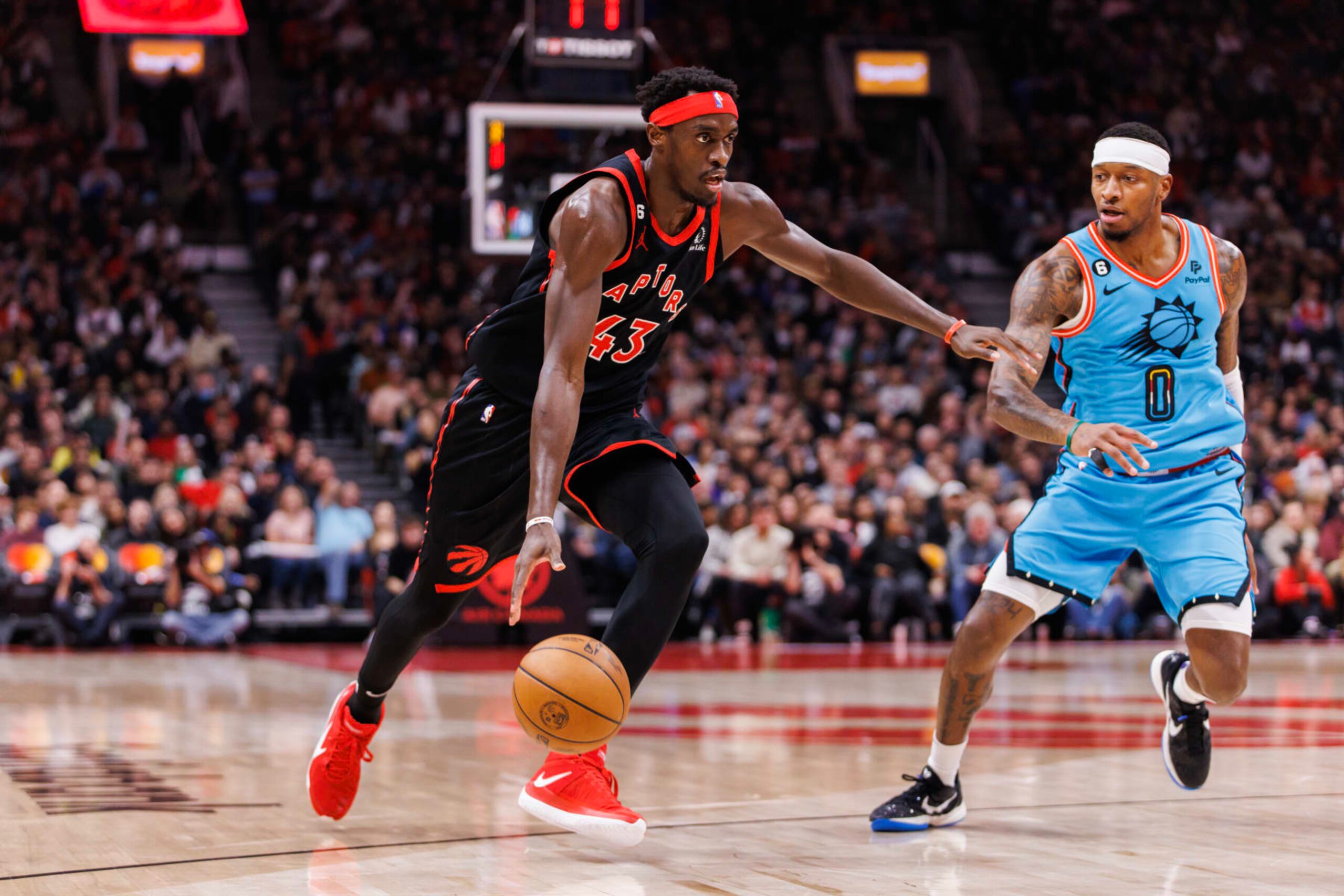 TORONTO, ON - DECEMBER 30: Pascal Siakam #43 of the Toronto Raptors drives to the net against Torrey Craig #0 of the Phoenix Suns during the first half of their NBA game at Scotiabank Arena on December 30, 2022 in Toronto, Canada. NOTE TO USER: User expressly acknowledges and agrees that, by downloading and or using this photograph, User is consenting to the terms and conditions of the Getty Images License Agreement. (Photo by Cole Burston/Getty Images)