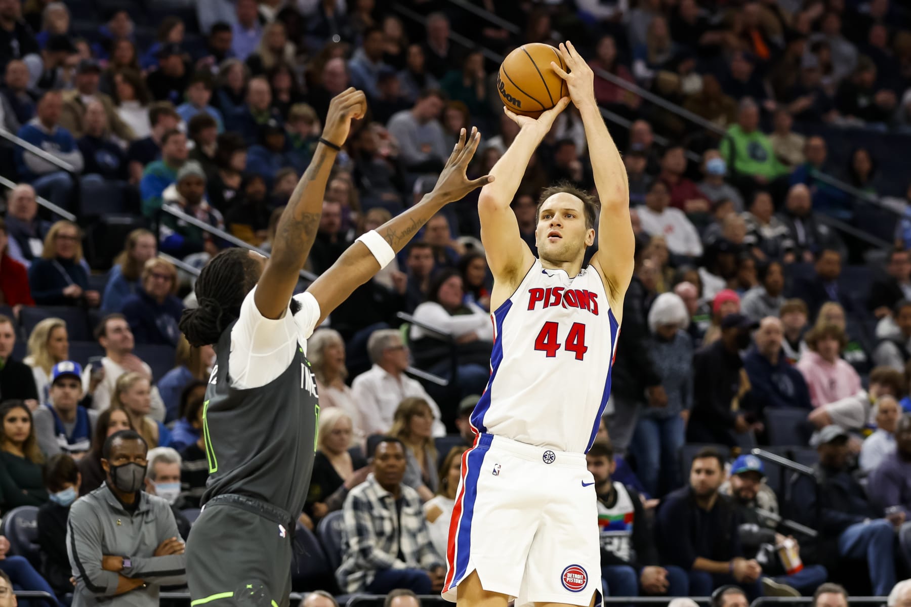 MINNEAPOLIS, MN - DECEMBER 31: Bojan Bogdanovic #44 of the Detroit Pistons shoots the ball while Naz Reid #11 of the Minnesota Timberwolves defends in the third quarter of the game at Target Center on December 31, 2022 in Minneapolis, Minnesota. The Pistons defeated the Timberwolves 116-104. NOTE TO USER: User expressly acknowledges and agrees that, by downloading and or using this Photograph, user is consenting to the terms and conditions of the Getty Images License Agreement. (Photo by David Berding/Getty Images)