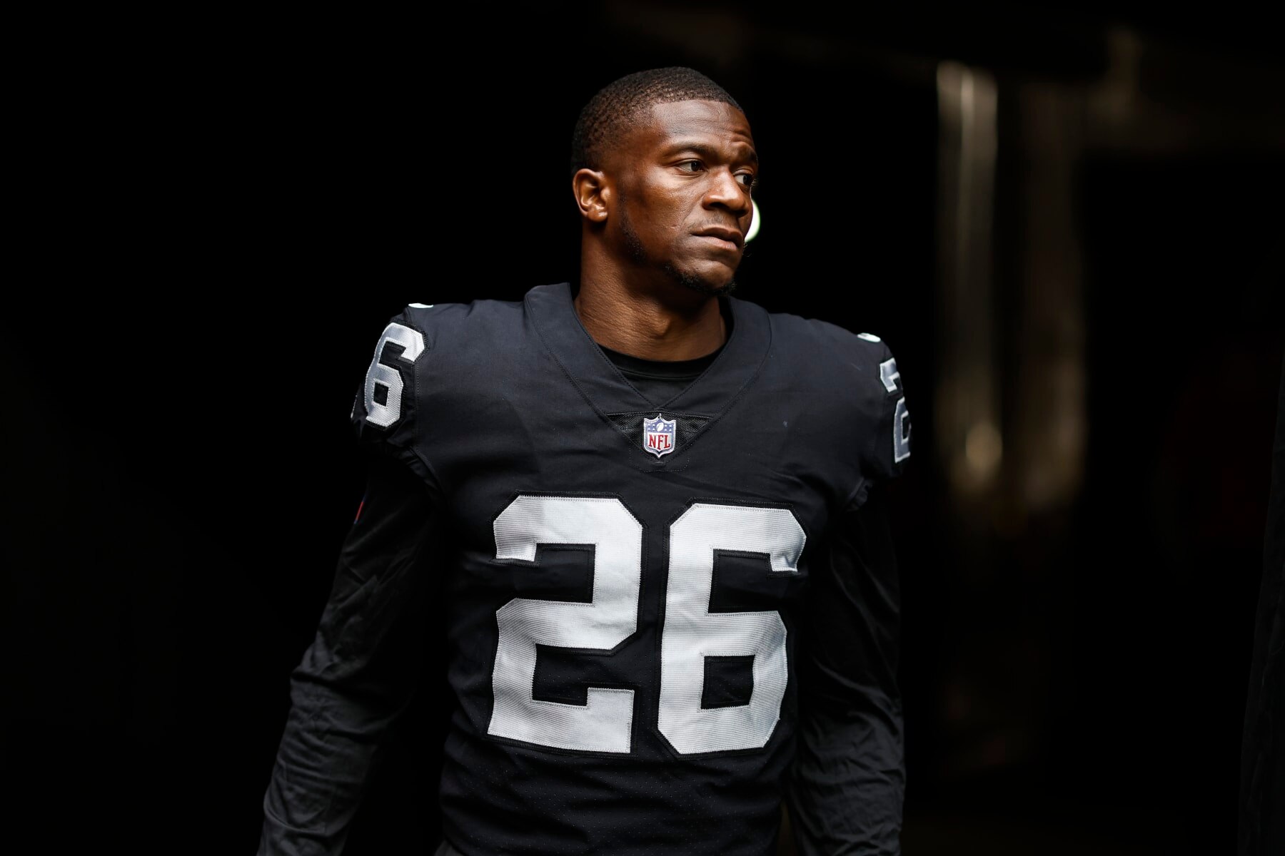 LAS VEGAS, NEVADA - SEPTEMBER 18: Rock Ya-Sin #26 of the Las Vegas Raiders walks through the tunnel to the field prior to an NFL football game between the Las Vegas Raiders and the Arizona Cardinals at Allegiant Stadium on September 18, 2022 in Las Vegas, Nevada. (Photo by Michael Owens/Getty Images)