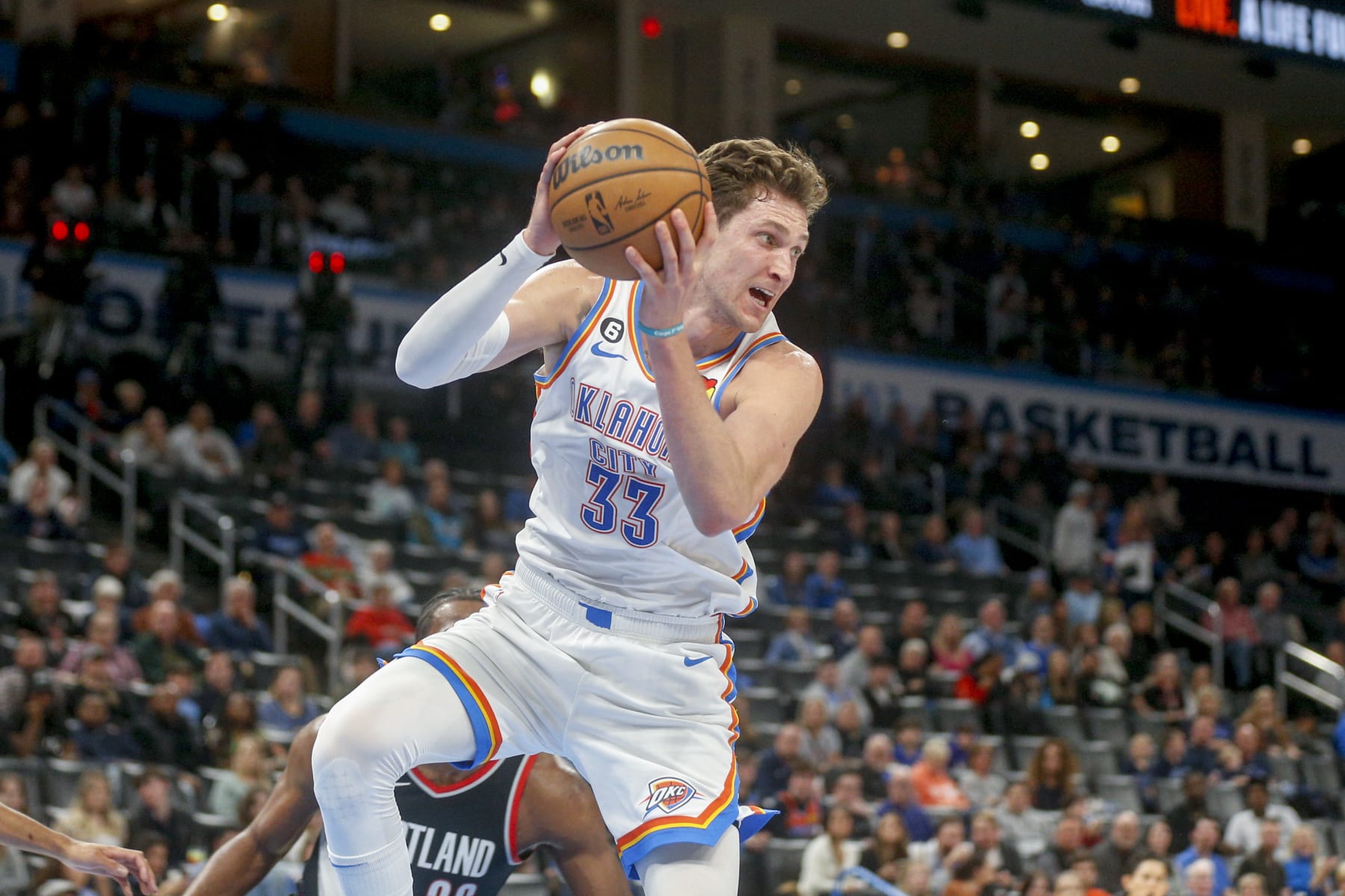 OKLAHOMA CITY, OKLAHOMA - DECEMBER 19: Mike Muscala #33 of the Oklahoma City Thunder grabs a rebound during the fourth quarter against the Portland Trail Blazers at Paycom Center on December 19, 2022 in Oklahoma City, Oklahoma. NOTE TO USER: User expressly acknowledges and agrees that, by downloading and or using this photograph, User is consenting to the terms and conditions of the Getty Images License Agreement.  (Photo by Ian Maule/Getty Images)