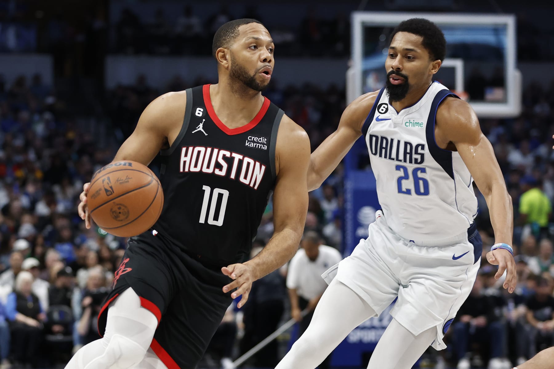 DALLAS, TEXAS - DECEMBER 29: Eric Gordon #10 of the Houston Rockets drives to the basket against Spencer Dinwiddie #26 of the Dallas Mavericks in the first half at American Airlines Center on December 29, 2022 in Dallas, Texas.  NOTE TO USER: User expressly acknowledges and agrees that, by downloading and or using this photograph, User is consenting to the terms and conditions of the Getty Images License Agreement. (Photo by Tim Heitman/Getty Images)