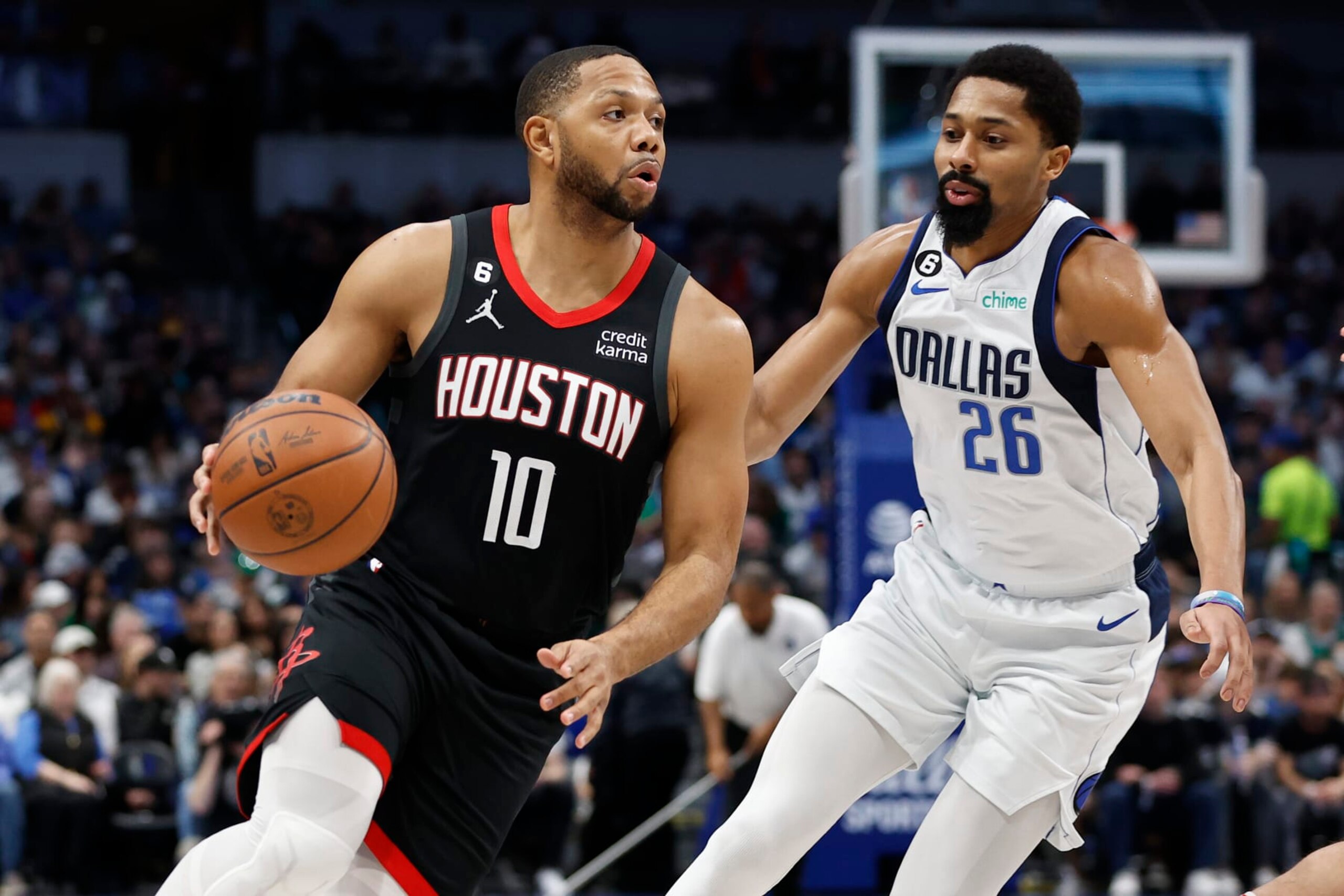 DALLAS, TEXAS - DECEMBER 29: Eric Gordon #10 of the Houston Rockets drives to the basket against Spencer Dinwiddie #26 of the Dallas Mavericks in the first half at American Airlines Center on December 29, 2022 in Dallas, Texas.  NOTE TO USER: User expressly acknowledges and agrees that, by downloading and or using this photograph, User is consenting to the terms and conditions of the Getty Images License Agreement. (Photo by Tim Heitman/Getty Images)
