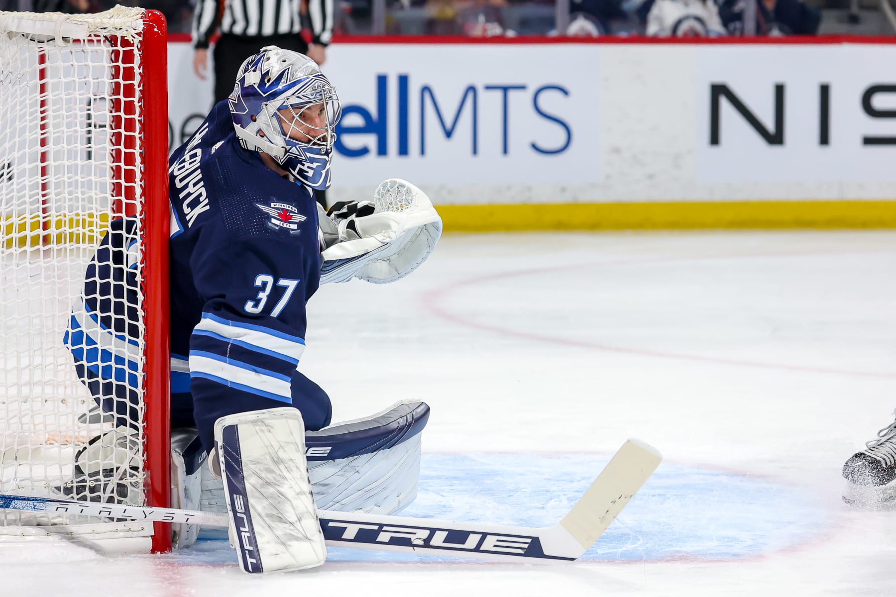 WINNIPEG, CANADA - JANUARY 3: Goaltender Connor Hellebuyck #37 of the Winnipeg Jets keeps an eye on the play as he guards the net during first period action against the Calgary Flames at the Canada Life Centre on January 3, 2023 in Winnipeg, Manitoba, Canada. (Photo by Jonathan Kozub/NHLI via Getty Images)