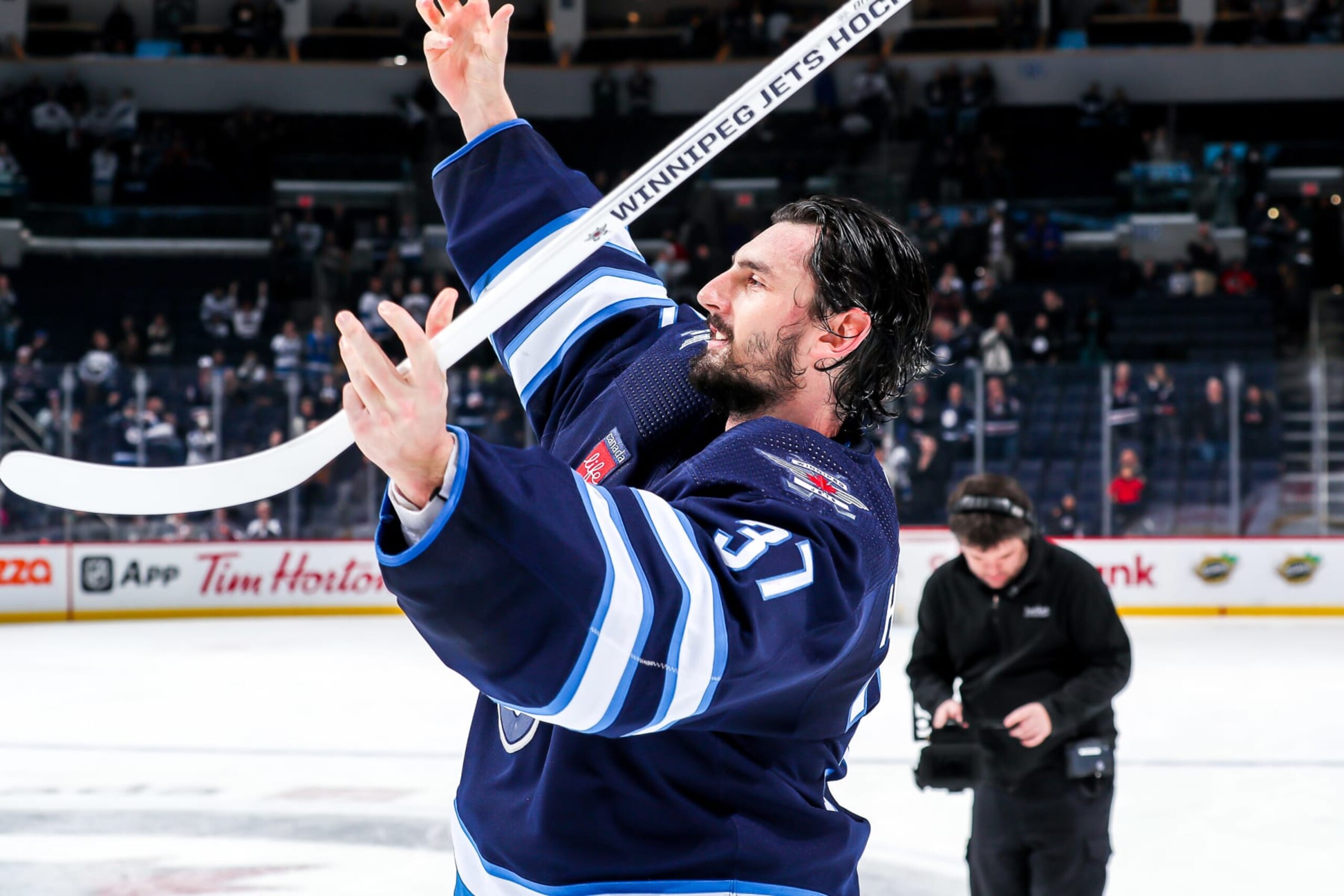 WINNIPEG, CANADA - JANUARY 3: Goaltender Connor Hellebuyck #37 of the Winnipeg Jets salutes the fans after receiving first star honours following a 3-2 victory over the Calgary Flames at the Canada Life Centre on January 3, 2023 in Winnipeg, Manitoba, Canada. (Photo by Darcy Finley/NHLI via Getty Images)