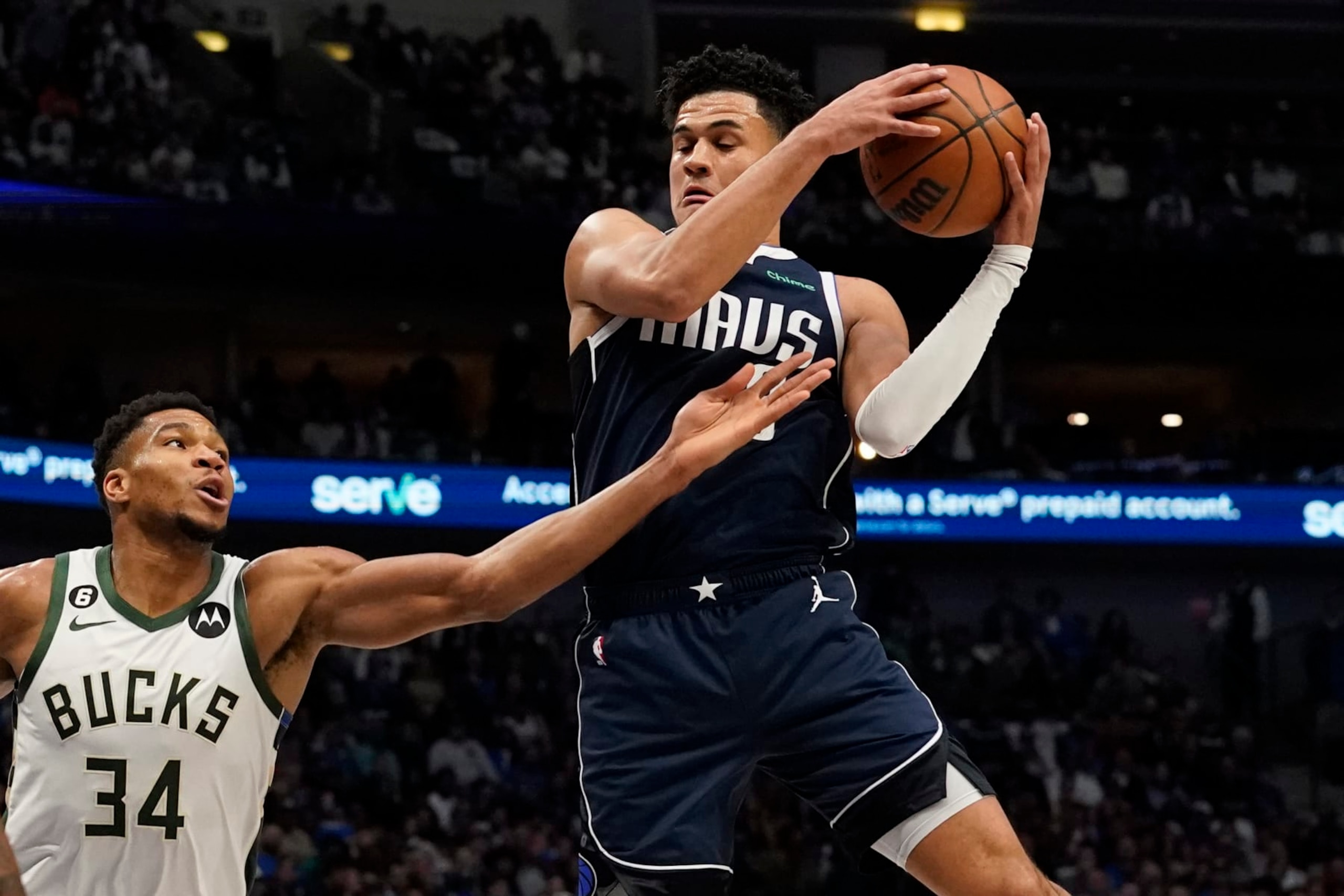 Dallas Mavericks guard Tyler Dorsey, right, grabs a rebound against Milwaukee Bucks forward Giannis Antetokounmpo (34) during the first half of an NBA basketball game in Dallas, Friday, Dec. 9, 2022. (AP Photo/LM Otero) Dallas Mavericks guard Tyler Dorsey, right, grabs a rebound against Milwaukee Bucks forward Giannis Antetokounmpo (34) during the first half of an NBA basketball game in Dallas, Friday, Dec. 9, 2022. (AP Photo/LM Otero)