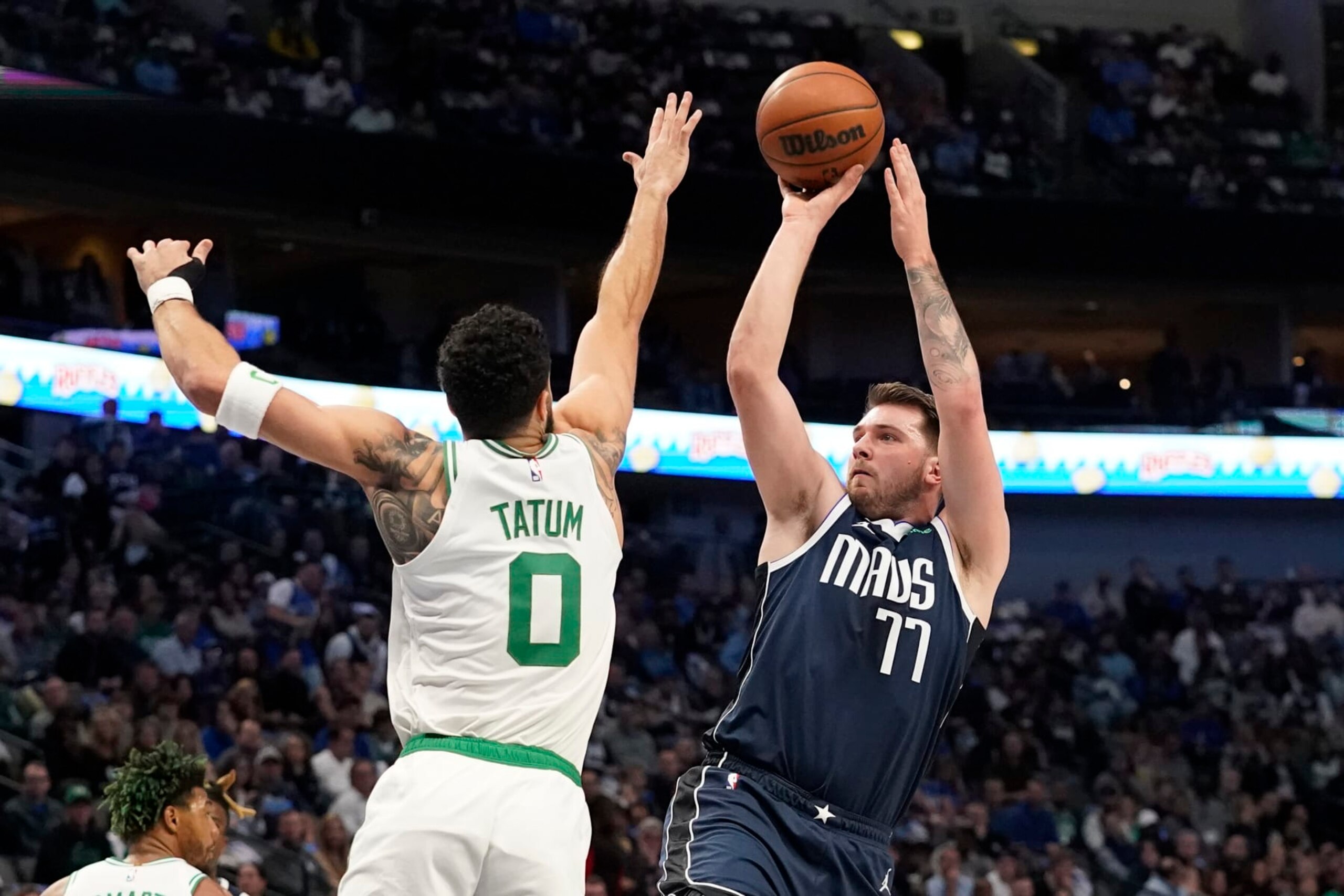 Dallas Mavericks guard Luka Doncic (77) shoots against Boston Celtics forward Jayson Tatum (0) during the first half of an NBA basketball game in Dallas, Thursday, Jan. 5, 2023. (AP Photo/LM Otero)
