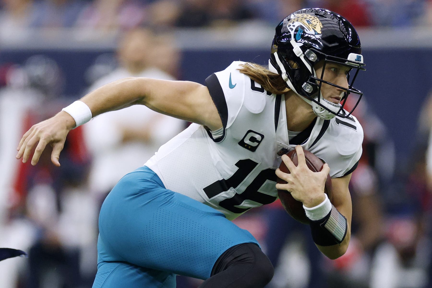HOUSTON, TEXAS - JANUARY 01: Trevor Lawrence #16 of the Jacksonville Jaguars carries the ball against the Houston Texans during the first quarter of the game at NRG Stadium on January 01, 2023 in Houston, Texas. (Photo by Tim Warner/Getty Images)