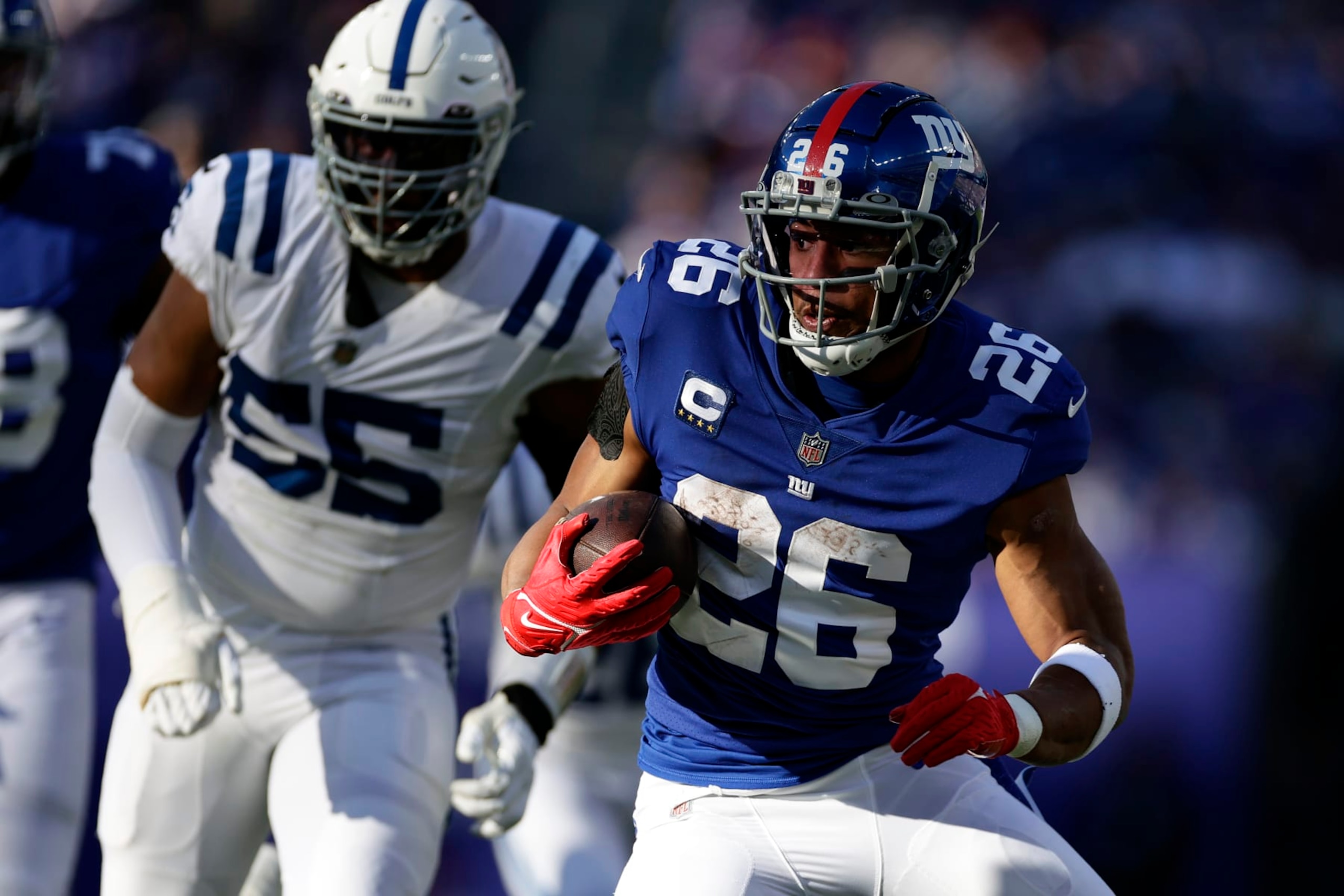 New York Giants running back Saquon Barkley (26) runs with the ball against the Indianapolis Colts during an NFL football game Sunday, Jan. 1, 2023, in East Rutherford, N.J. (AP Photo/Adam Hunger)