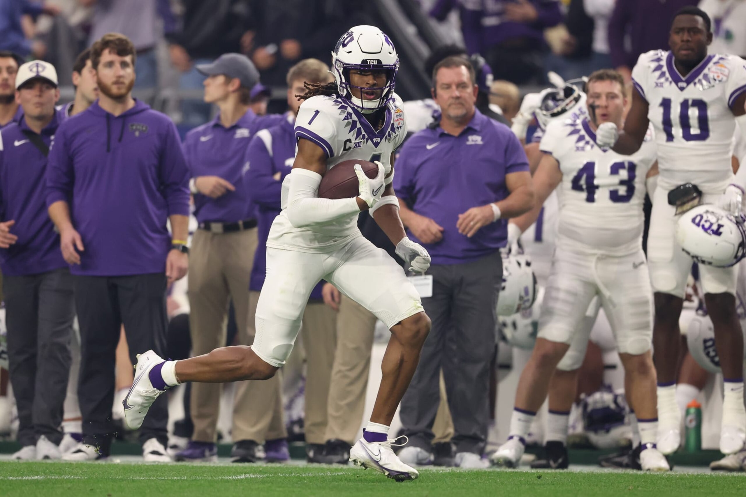 GLENDALE, ARIZONA - DECEMBER 31: Wide receiver Quentin Johnston #1 of the TCU Horned Frogs runs with the football after a reception against the Michigan Wolverines during the Vrbo Fiesta Bowl at State Farm Stadium on December 31, 2022 in Glendale, Arizona. The Horned Frogs defeated the Wolverines 51-45.  (Photo by Christian Petersen/Getty Images)