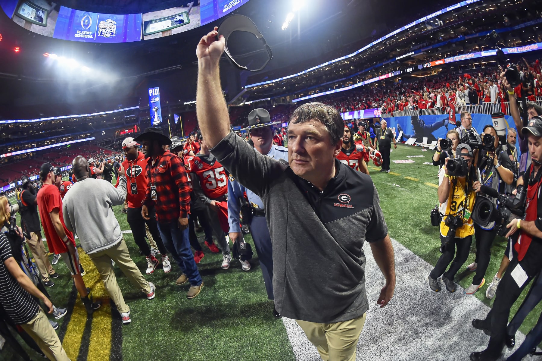 ATLANTA, GA - December 31: Georgia Bulldogs coach Kirby Smart acknowledges the fans as he walks off the field after a College Football Semifinal game between the Ohio State Buckeyes and Georgia Bulldogs in the Chick-Fil-A Peach Bowl on Saturday, December 31, 2022 at Mercedes-Benz Stadium in Atlanta, GA. (Photo by Austin McAfee/Icon Sportswire via Getty Images)
