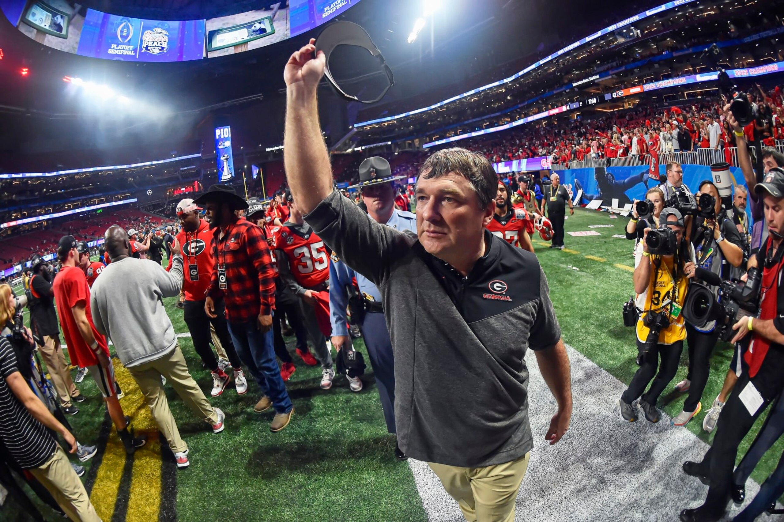 ATLANTA, GA - December 31: Georgia Bulldogs coach Kirby Smart acknowledges the fans as he walks off the field after a College Football Semifinal game between the Ohio State Buckeyes and Georgia Bulldogs in the Chick-Fil-A Peach Bowl on Saturday, December 31, 2022 at Mercedes-Benz Stadium in Atlanta, GA. (Photo by Austin McAfee/Icon Sportswire via Getty Images)