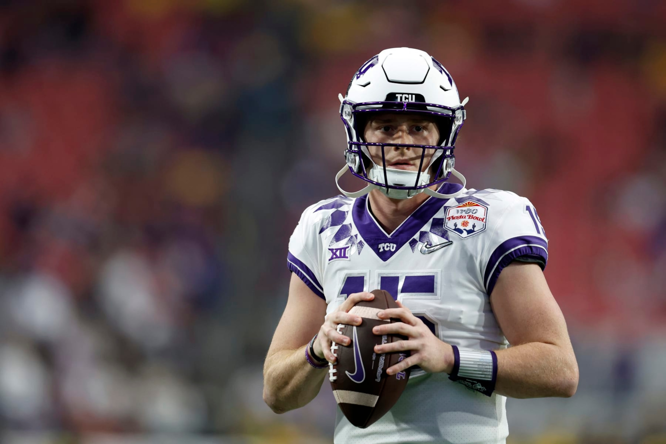 GLENDALE, ARIZONA - DECEMBER 31: Quarterback Max Duggan #15 of the TCU Horned Frogs warms up before the Vrbo Fiesta Bowl against the Michigan Wolverines at State Farm Stadium on December 31, 2022 in Glendale, Arizona. The Horned Frogs defeated the Wolverines 51-45. (Photo by Chris Coduto/Getty Images) GLENDALE, ARIZONA - DECEMBER 31: Quarterback Max Duggan #15 of the TCU Horned Frogs warms up before the Vrbo Fiesta Bowl against the Michigan Wolverines at State Farm Stadium on December 31, 2022 in Glendale, Arizona. The Horned Frogs defeated the Wolverines 51-45. (Photo by Chris Coduto/Getty Images)