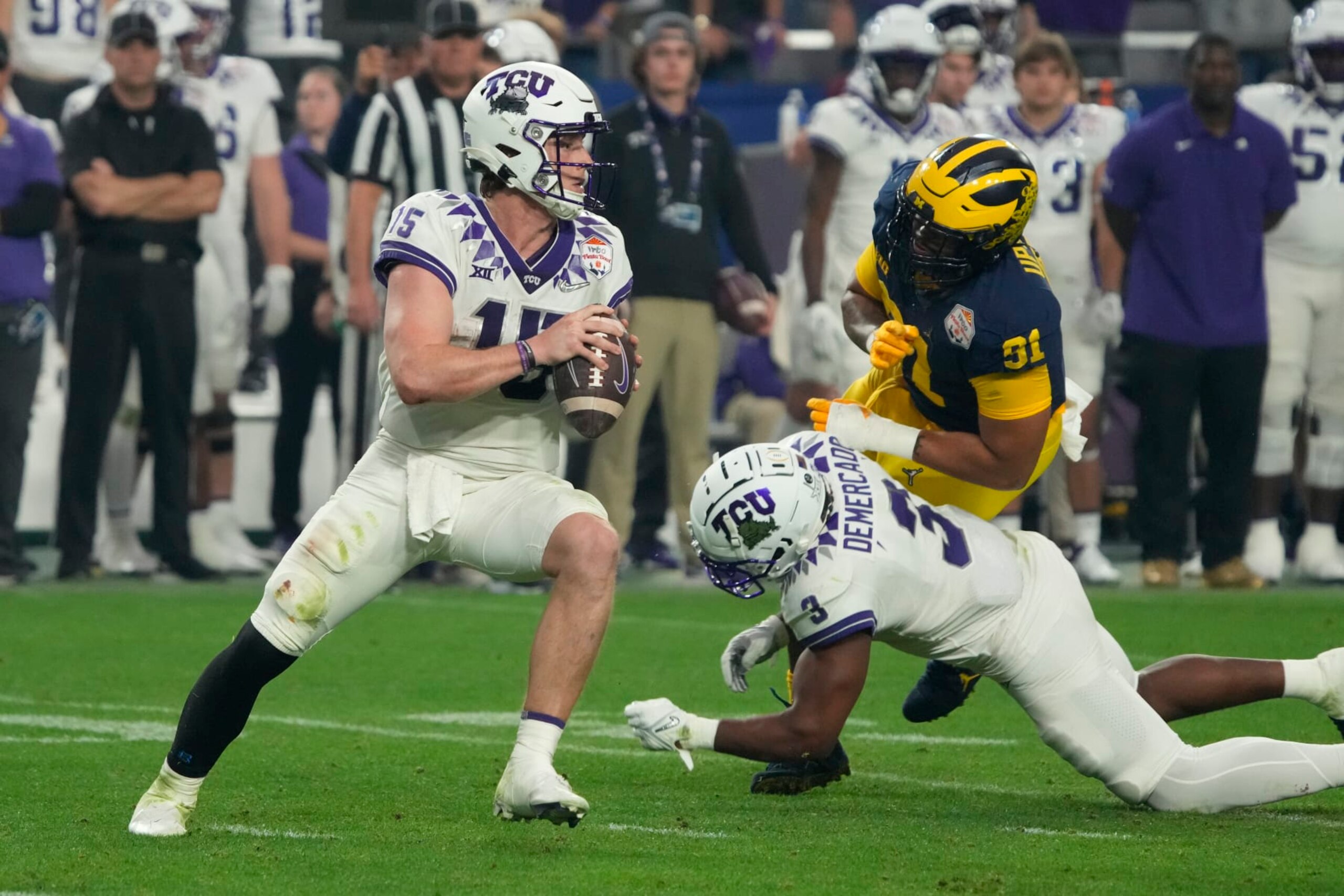 TCU quarterback Max Duggan (15) during the first half of the Fiesta Bowl NCAA college football semifinal playoff game against Michigan, Saturday, Dec. 31, 2022, in Glendale, Arizona. (AP Photo/Rick Scuteri) TCU quarterback Max Duggan (15) during the first half of the Fiesta Bowl NCAA college football semifinal playoff game against Michigan, Saturday, Dec. 31, 2022, in Glendale, Arizona. (AP Photo/Rick Scuteri)