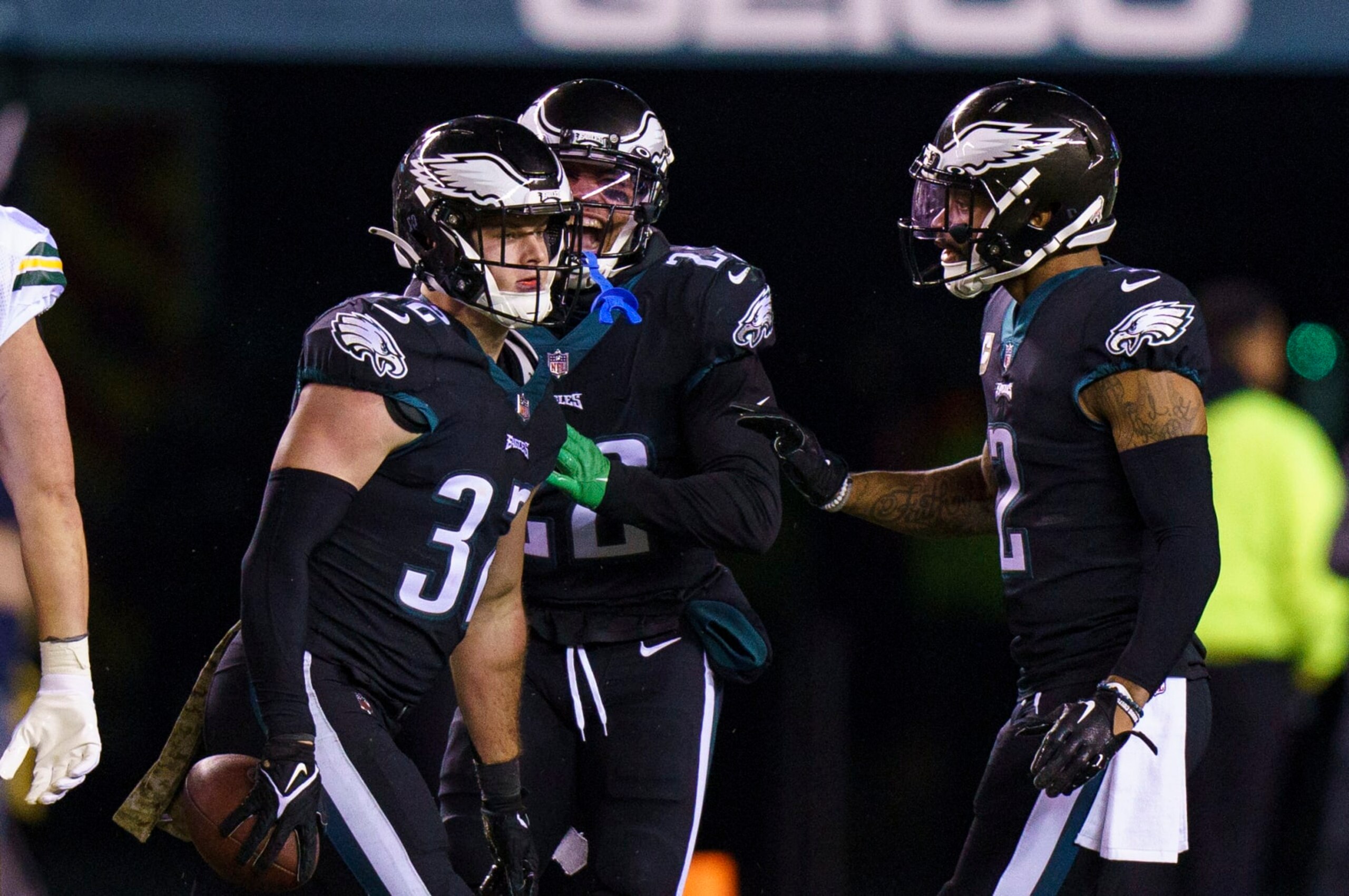 Philadelphia Eagles safety Reed Blankenship (32) with the interception as safety Marcus Epps (22) and cornerback Darius Slay (2) comes over to celebrate during the NFL football game against the Green Bay Packers, Sunday, Nov. 27, 2022, in Philadelphia. (AP Photo/Chris Szagola)