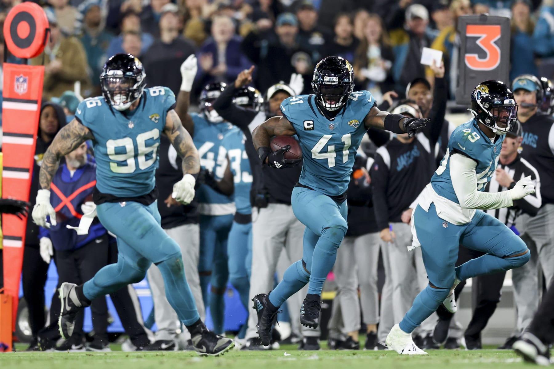 JACKSONVILLE, FLORIDA - JANUARY 07: Adam Gotsis #96 of the Jacksonville Jaguars and Arden Key #49 of the Jacksonville Jaguars look to block while Josh Allen #41 of the Jacksonville Jaguars returns a fumble for a go ahead touchdown during the fourth quarter against the Tennessee Titans at TIAA Bank Field on January 07, 2023 in Jacksonville, Florida. (Photo by Mike Carlson/Getty Images)