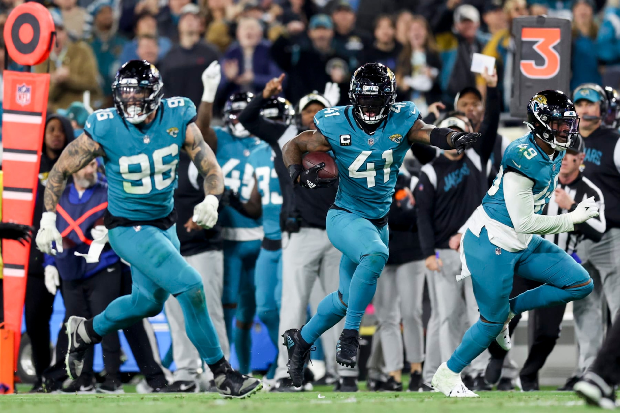 JACKSONVILLE, FLORIDA - JANUARY 07: Adam Gotsis #96 of the Jacksonville Jaguars and Arden Key #49 of the Jacksonville Jaguars look to block while Josh Allen #41 of the Jacksonville Jaguars returns a fumble for a go ahead touchdown during the fourth quarter against the Tennessee Titans at TIAA Bank Field on January 07, 2023 in Jacksonville, Florida. (Photo by Mike Carlson/Getty Images)