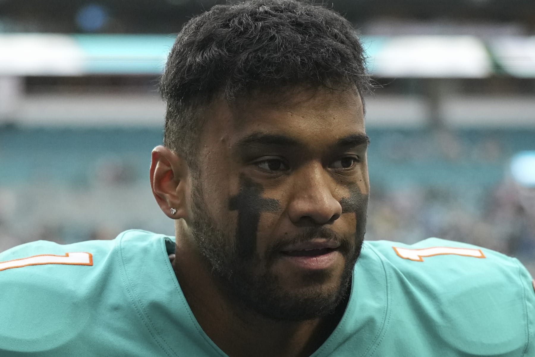 Miami Dolphins quarterback Tua Tagovailoa (1) walks off the field after an NFL football game against the Green Bay Packers, Sunday, Dec. 25, 2022, in Miami Gardens, Fla. (AP Photo/Jim Rassol)