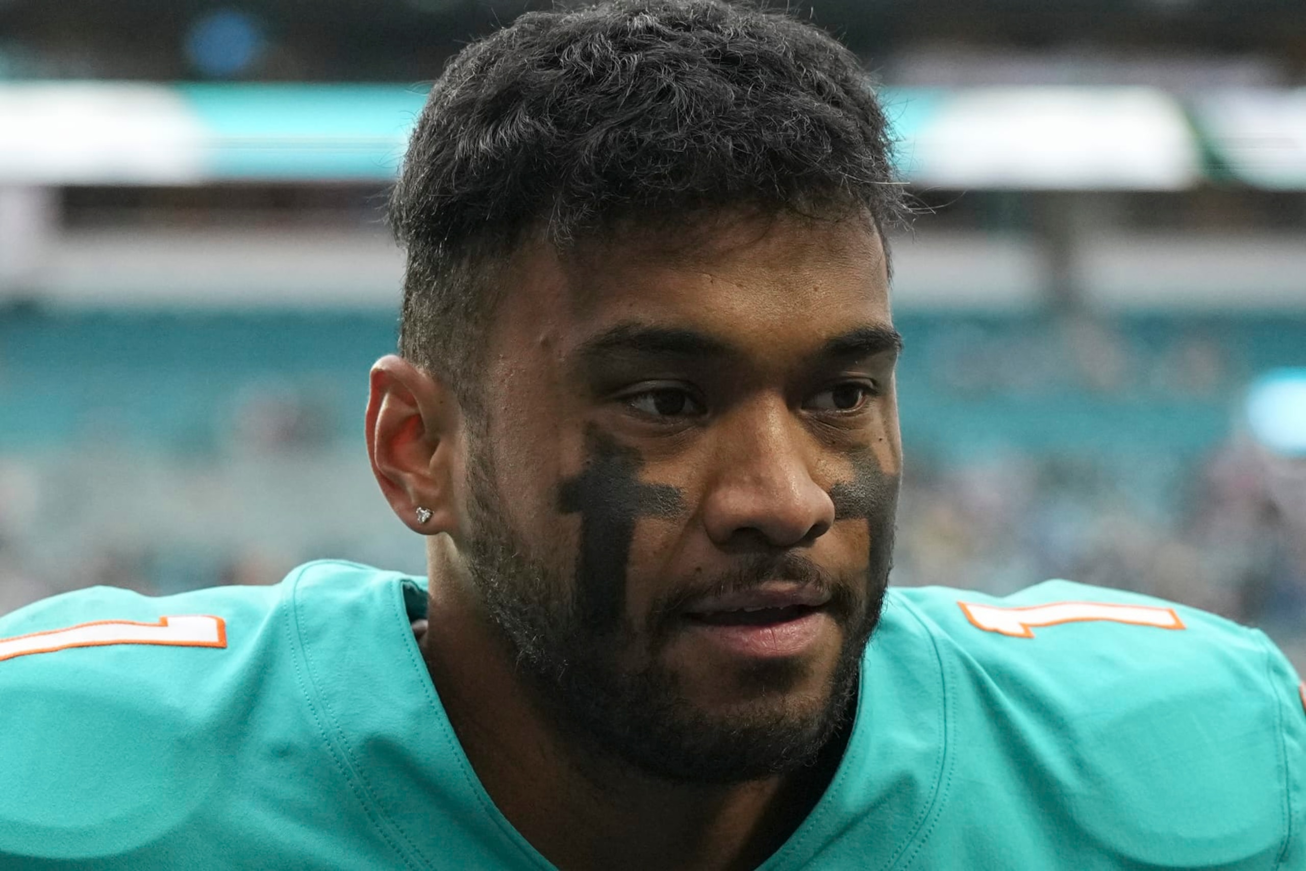 Miami Dolphins quarterback Tua Tagovailoa (1) walks off the field after an NFL football game against the Green Bay Packers, Sunday, Dec. 25, 2022, in Miami Gardens, Fla. (AP Photo/Jim Rassol)