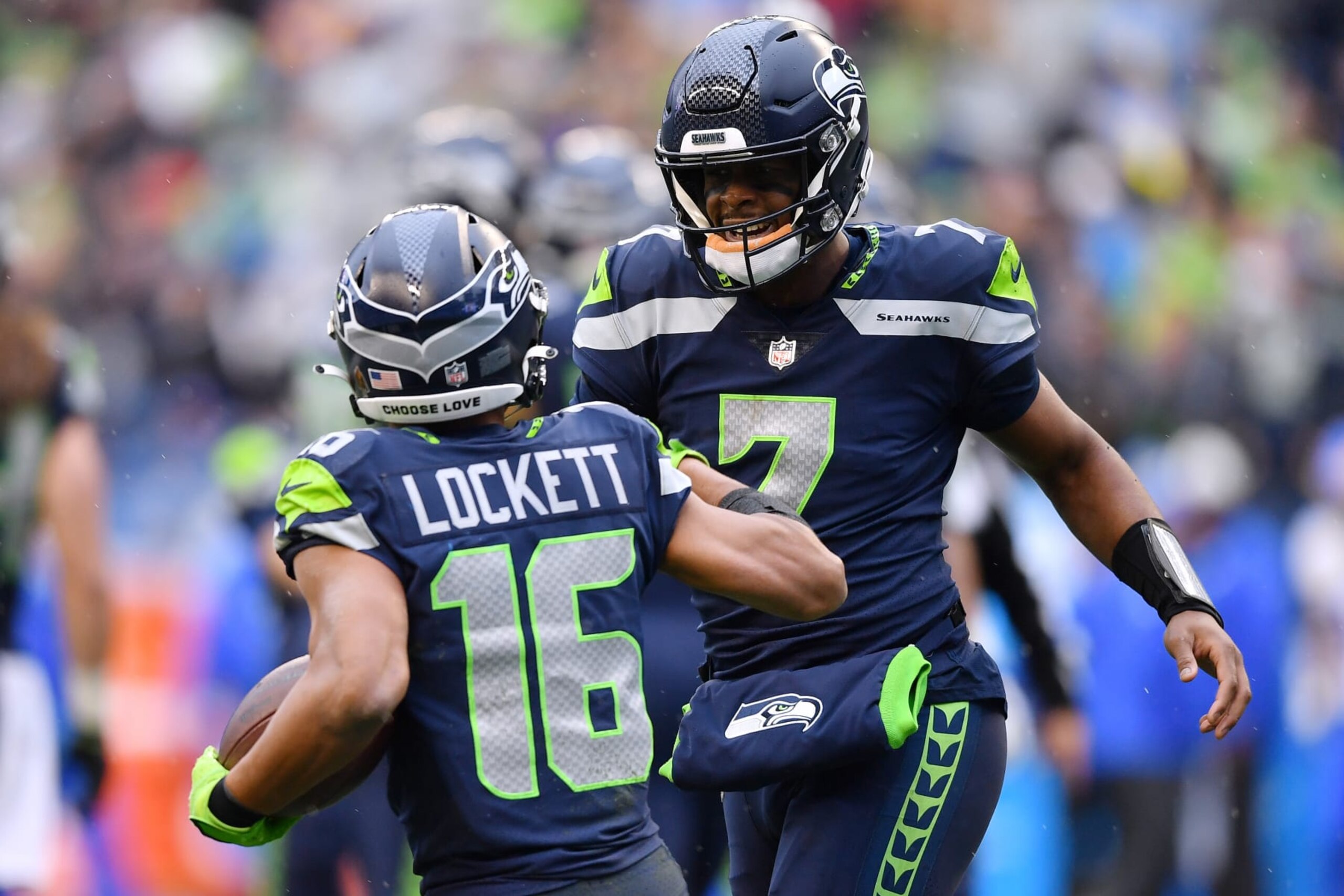 SEATTLE, WASHINGTON - JANUARY 08: Tyler Lockett #16 of the Seattle Seahawks celebrates his touchdown catch with Geno Smith #7 during the third quarter against the Los Angeles Rams at Lumen Field on January 08, 2023 in Seattle, Washington. (Photo by Jane Gershovich/Getty Images)
