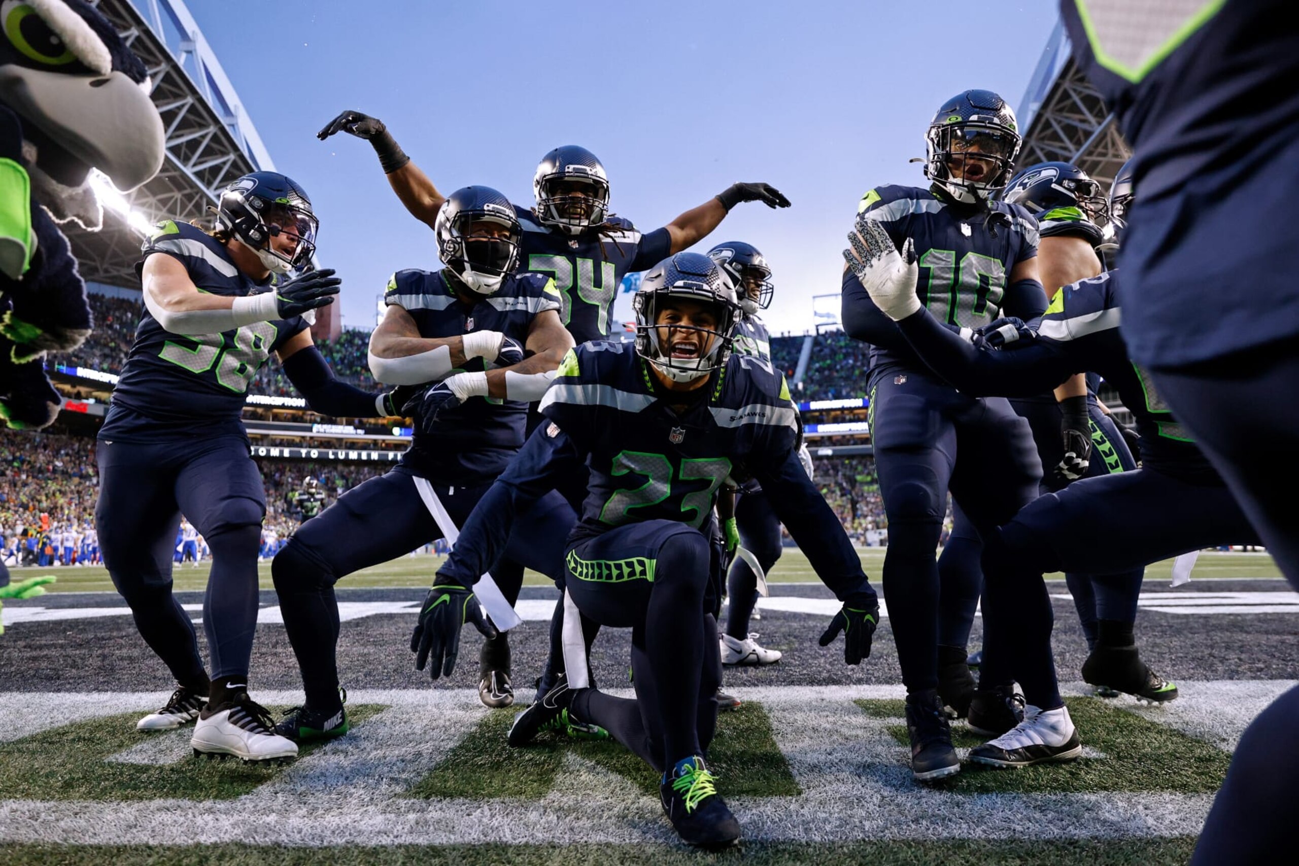 SEATTLE, WASHINGTON - JANUARY 08: The Seattle Seahawks celebrate an interception by Quandre Diggs #6 against the Los Angeles Rams during overtime at Lumen Field on January 08, 2023 in Seattle, Washington. (Photo by Steph Chambers/Getty Images)