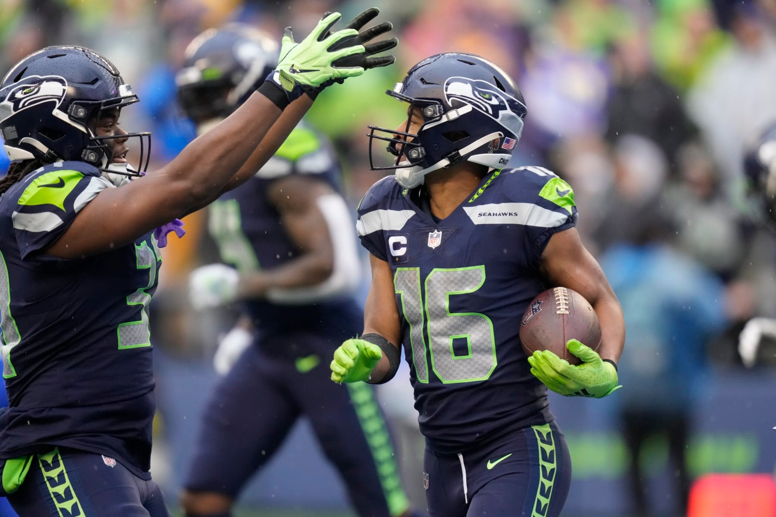 Seattle Seahawks wide receiver Tyler Lockett (16) celebrates a touchdown with teammates during an NFL football game against the Los Angeles Rams, Sunday, Jan. 8, 2023, in Seattle, WA. The Seahawks defeated the Rams in overtime 19-16. (AP Photo/Ben VanHouten)