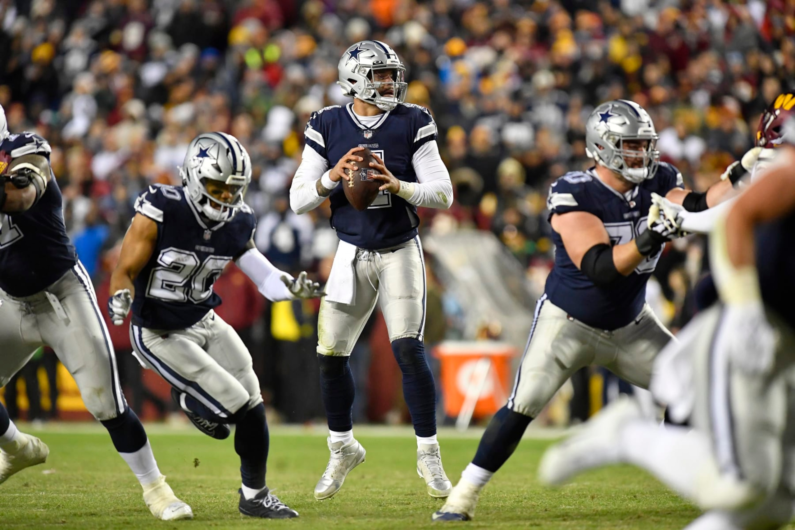 LANDOVER, MD - JANUARY 08: Cowboys quarterback Dak Prescott (4) sits in the pocket looking for an open receiver during the Dallas Cowboys versus Washington Commanders National Football League game at FedEx Field on January 8, 2023 in Landover, MD. (Photo by Randy Litzinger/Icon Sportswire via Getty Images)