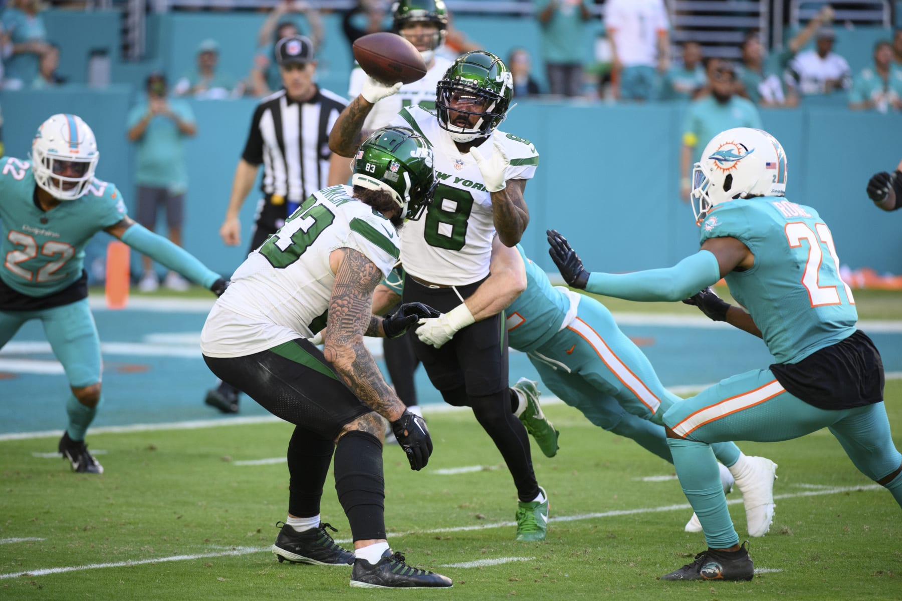 New York Jets wide receiver Elijah Moore (8) catches the ball from New York Jets quarterback Joe Flacco (not shown) and throws the ball to New York Jets wide receiver Corey Davis (not shown) during a trick play in the final seconds which resulted in a safety for the Miami Dolphins during an NFL football game, Sunday, Jan. 8, 2023, in Miami Gardens, Fla. (AP Photo/Doug Murray)