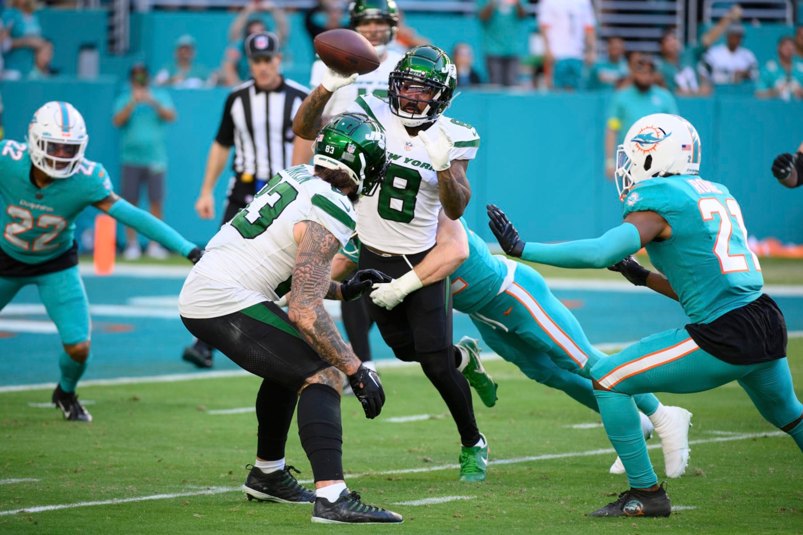 New York Jets wide receiver Elijah Moore (8) catches the ball from New York Jets quarterback Joe Flacco (not shown) and throws the ball to New York Jets wide receiver Corey Davis (not shown) during a trick play in the final seconds which resulted in a safety for the Miami Dolphins during an NFL football game, Sunday, Jan. 8, 2023, in Miami Gardens, Fla. (AP Photo/Doug Murray)