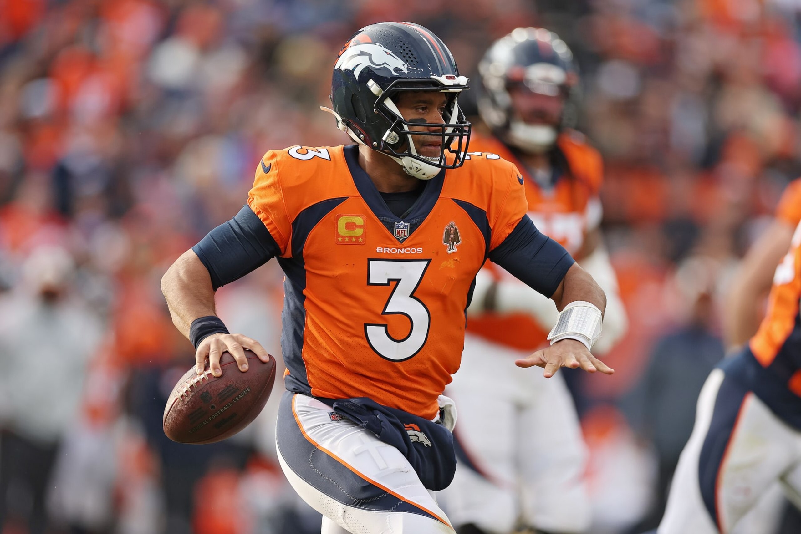DENVER, COLORADO - JANUARY 08: Russell Wilson #3 of the Denver Broncos attempts a pass during the third quarter against the Los Angeles Chargers at Empower Field At Mile High on January 08, 2023 in Denver, Colorado. (Photo by Matthew Stockman/Getty Images)