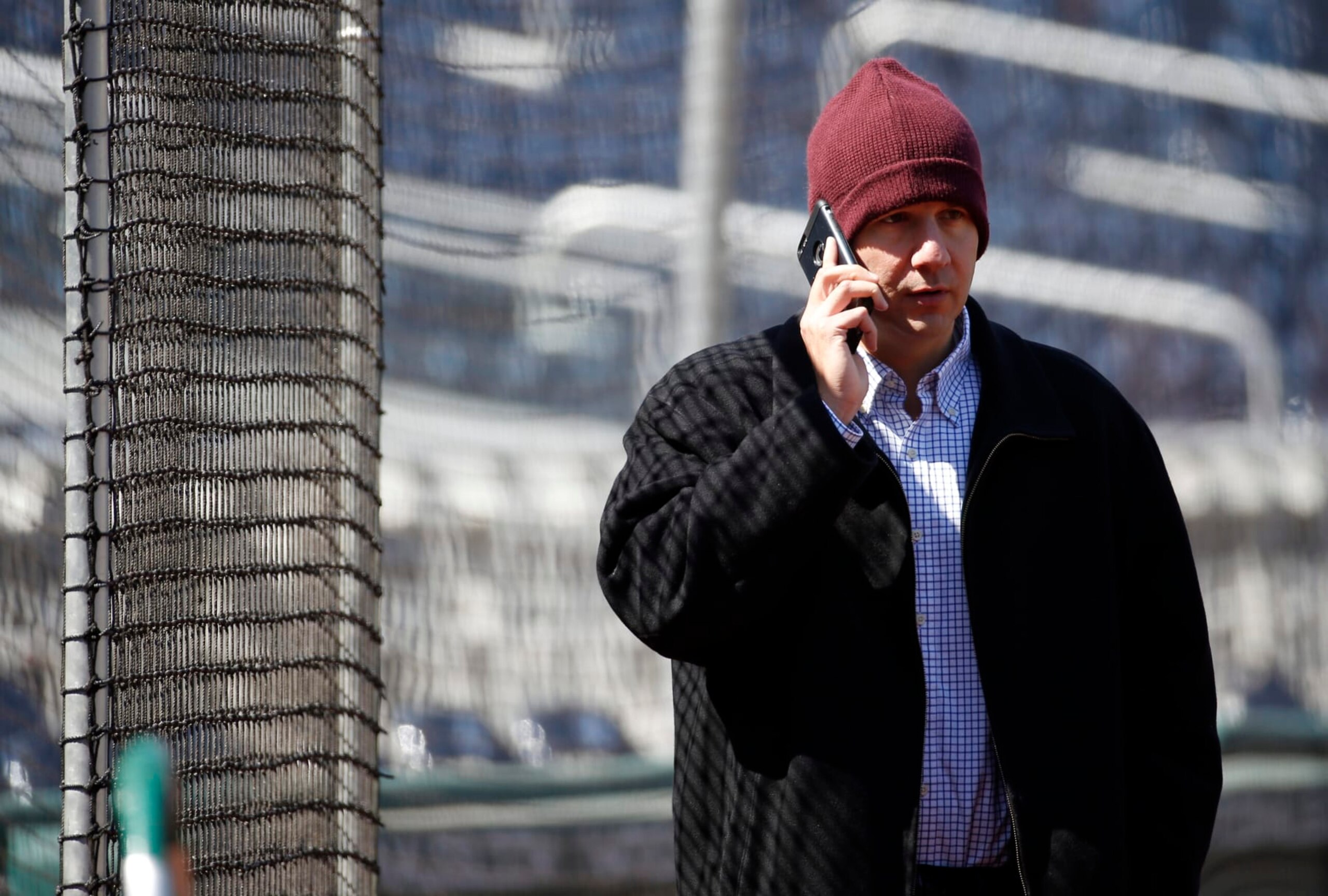 Atlanta Braves general manager John Coppolella talks on the phone before a baseball game against the Washington Nationals at Nationals Park, Wednesday, April 13, 2016, in Washington. Braves outfielder Hector Olivera was placed on paid administrative leave by Major League Baseball after he was arrested when a woman accused him of assault at a hotel outside Washington. (AP Photo/Alex Brandon)