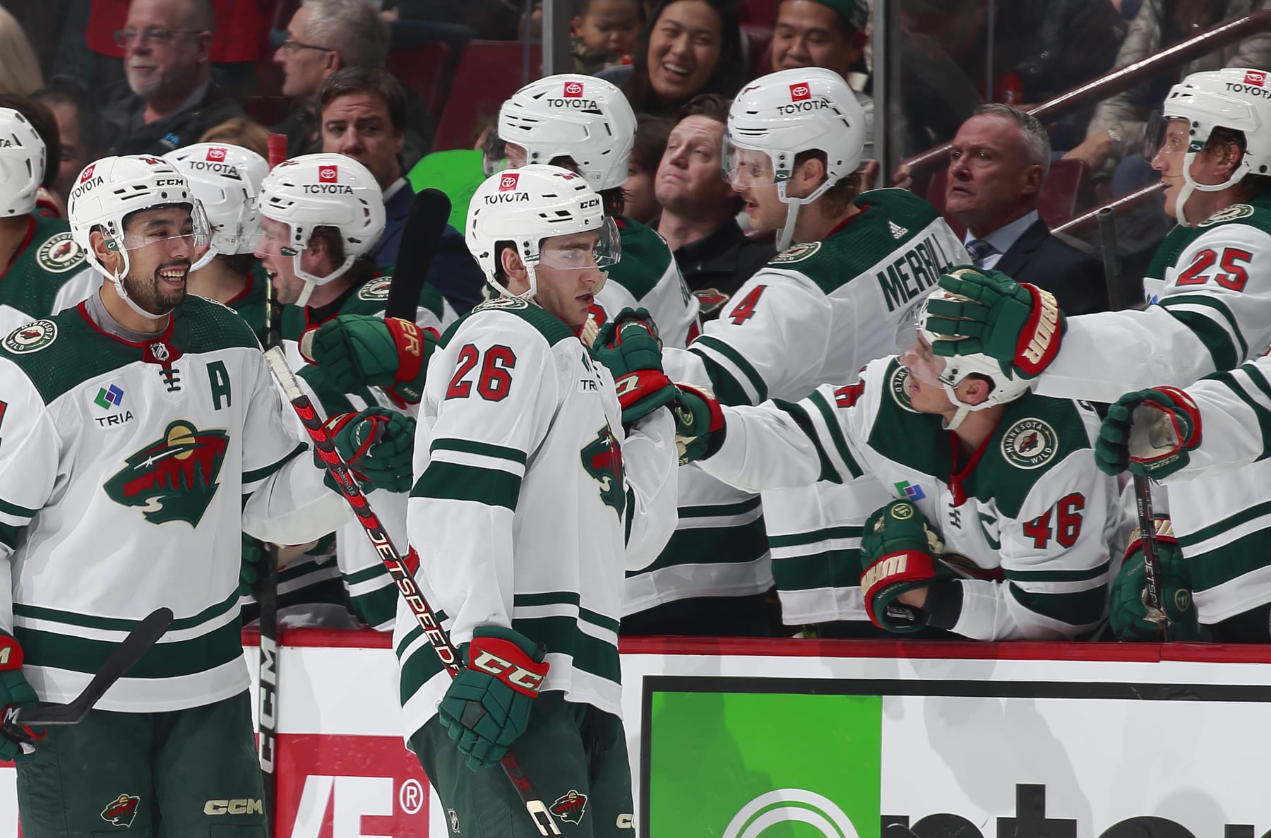VANCOUVER, CANADA - DECEMBER 10: Connor Dewar #26 of the Minnesota Wild celebrates his goal with teammates during the second period of their NHL game against the Vancouver Canucks at Rogers Arena December 10, 2022 in Vancouver, British Columbia, Canada.  (Photo by Jeff Vinnick/NHLI via Getty Images)