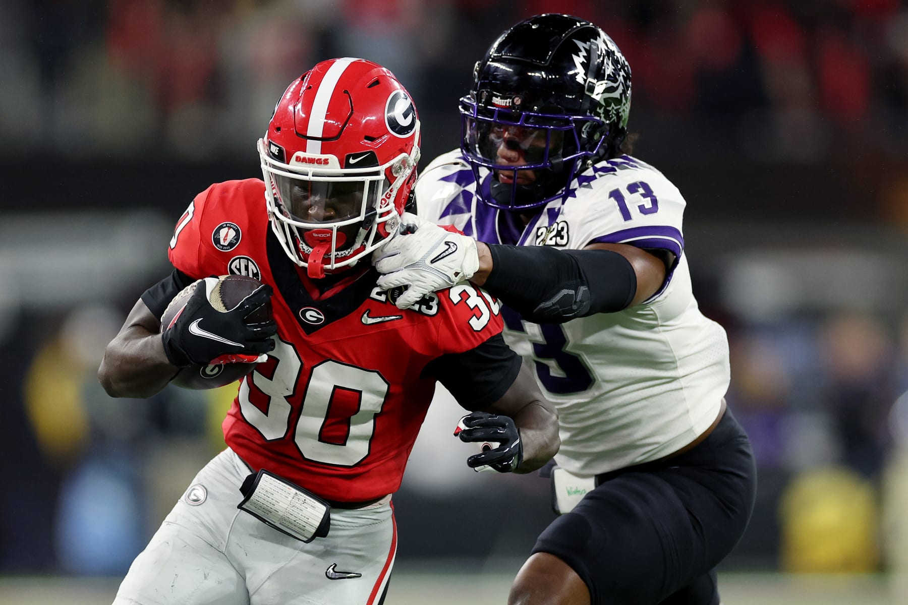 INGLEWOOD, CALIFORNIA - JANUARY 09: Daijun Edwards #30 of the Georgia Bulldogs runs with the ball against Dee Winters #13 of the TCU Horned Frogs in the second quarter in the College Football Playoff National Championship game at SoFi Stadium on January 09, 2023 in Inglewood, California. (Photo by Ezra Shaw/Getty Images)