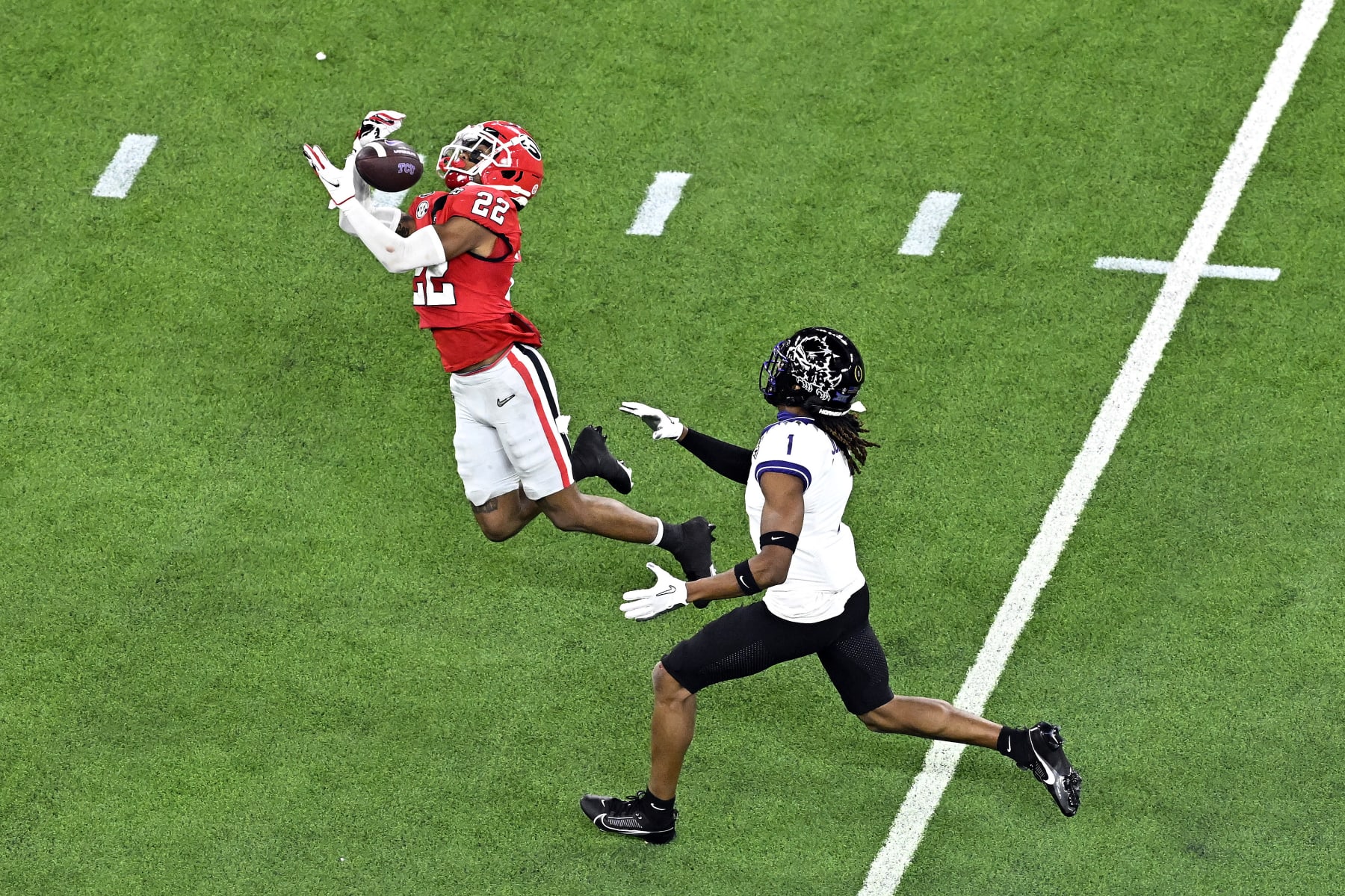 INGLEWOOD, CALIFORNIA - JANUARY 09: Javon Bullard #22 of the Georgia Bulldogs intercepts a pass intended for Quentin Johnston #1 of the TCU Horned Frogs in the second quarter in the College Football Playoff National Championship game at SoFi Stadium on January 09, 2023 in Inglewood, California. (Photo by Kevork Djansezian/Getty Images)