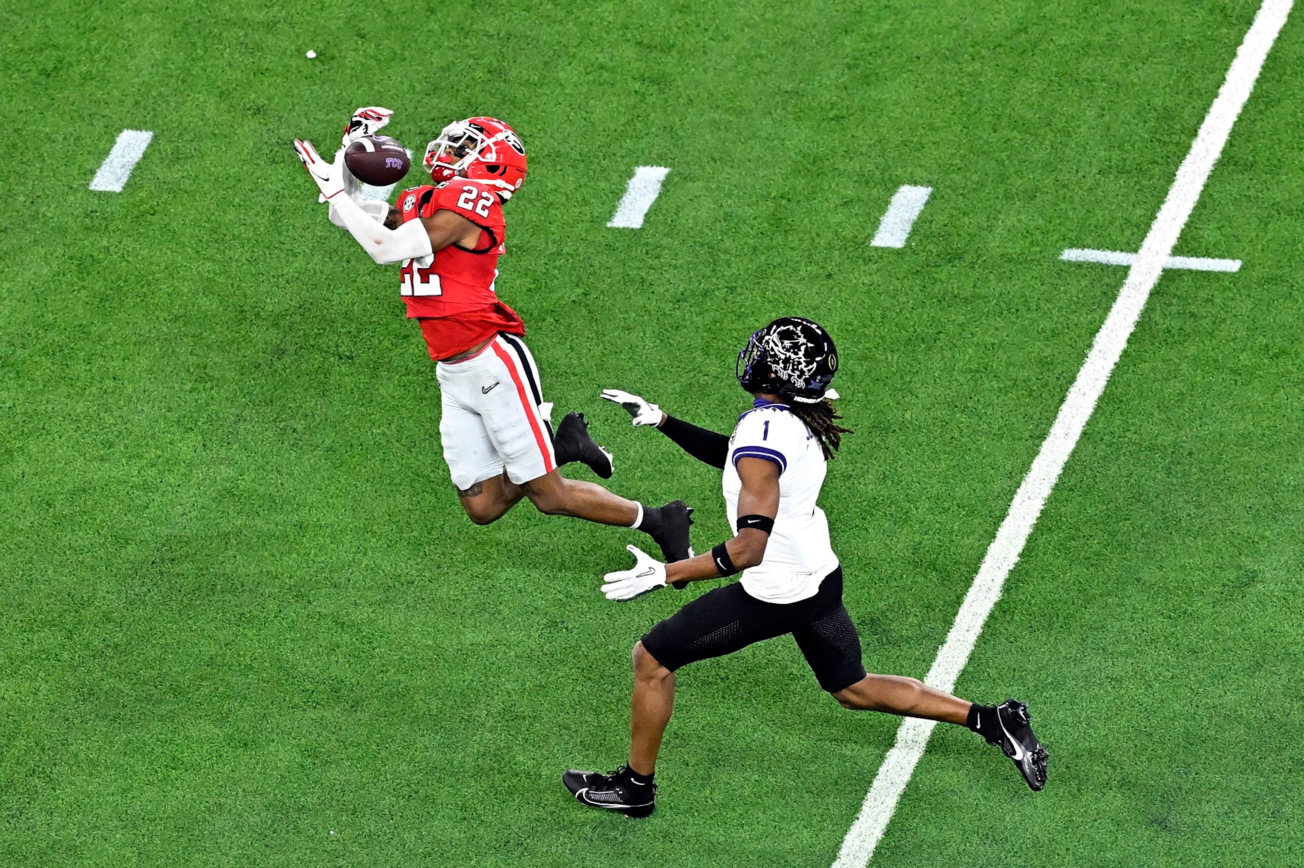 INGLEWOOD, CALIFORNIA - JANUARY 09: Javon Bullard #22 of the Georgia Bulldogs intercepts a pass intended for Quentin Johnston #1 of the TCU Horned Frogs in the second quarter in the College Football Playoff National Championship game at SoFi Stadium on January 09, 2023 in Inglewood, California. (Photo by Kevork Djansezian/Getty Images)
