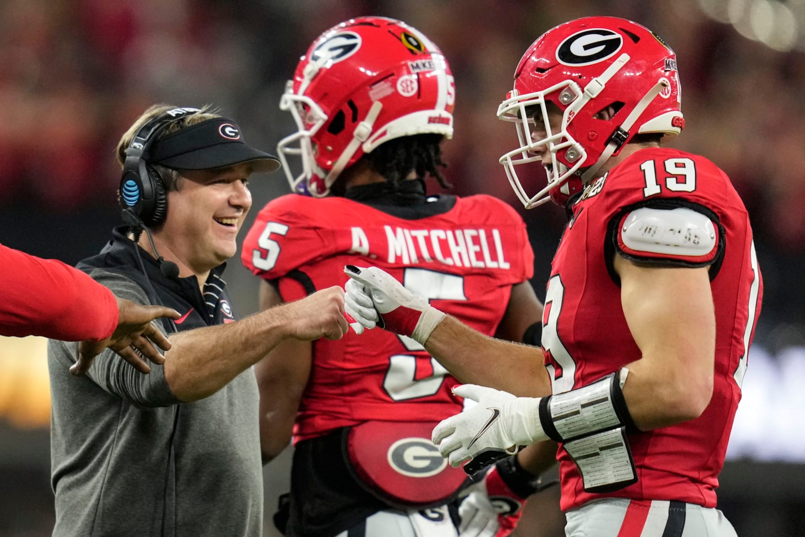 Georgia tight end Brock Bowers (19) celebrates his touchdown with Georgia head coach Kirby Smart during the second half of the national championship NCAA College Football Playoff game against TCU, Monday, Jan. 9, 2023, in Inglewood, Calif. (AP Photo/Ashley Landis)