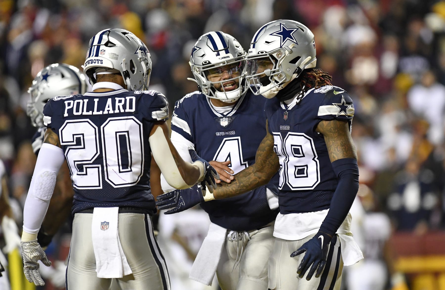 LANDOVER, MD - JANUARY 08: Cowboys running back Tony Pollard (20) and quarterback Dak Prescott (4) congratulate wide receiver CeeDee Lamb (88) after his touchdown catch during the Dallas Cowboys versus Washington Commanders National Football League game at FedEx Field on January 8, 2023 in Landover, MD. (Photo by Randy Litzinger/Icon Sportswire via Getty Images)