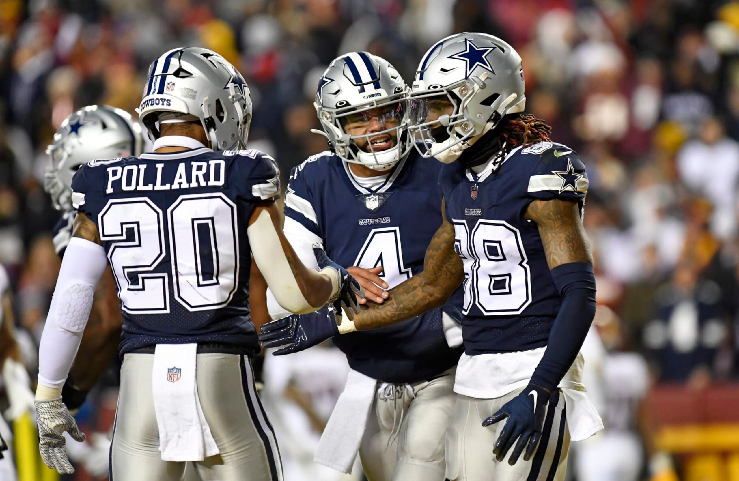 LANDOVER, MD - JANUARY 08: Cowboys running back Tony Pollard (20) and quarterback Dak Prescott (4) congratulate wide receiver CeeDee Lamb (88) after his touchdown catch during the Dallas Cowboys versus Washington Commanders National Football League game at FedEx Field on January 8, 2023 in Landover, MD. (Photo by Randy Litzinger/Icon Sportswire via Getty Images)
