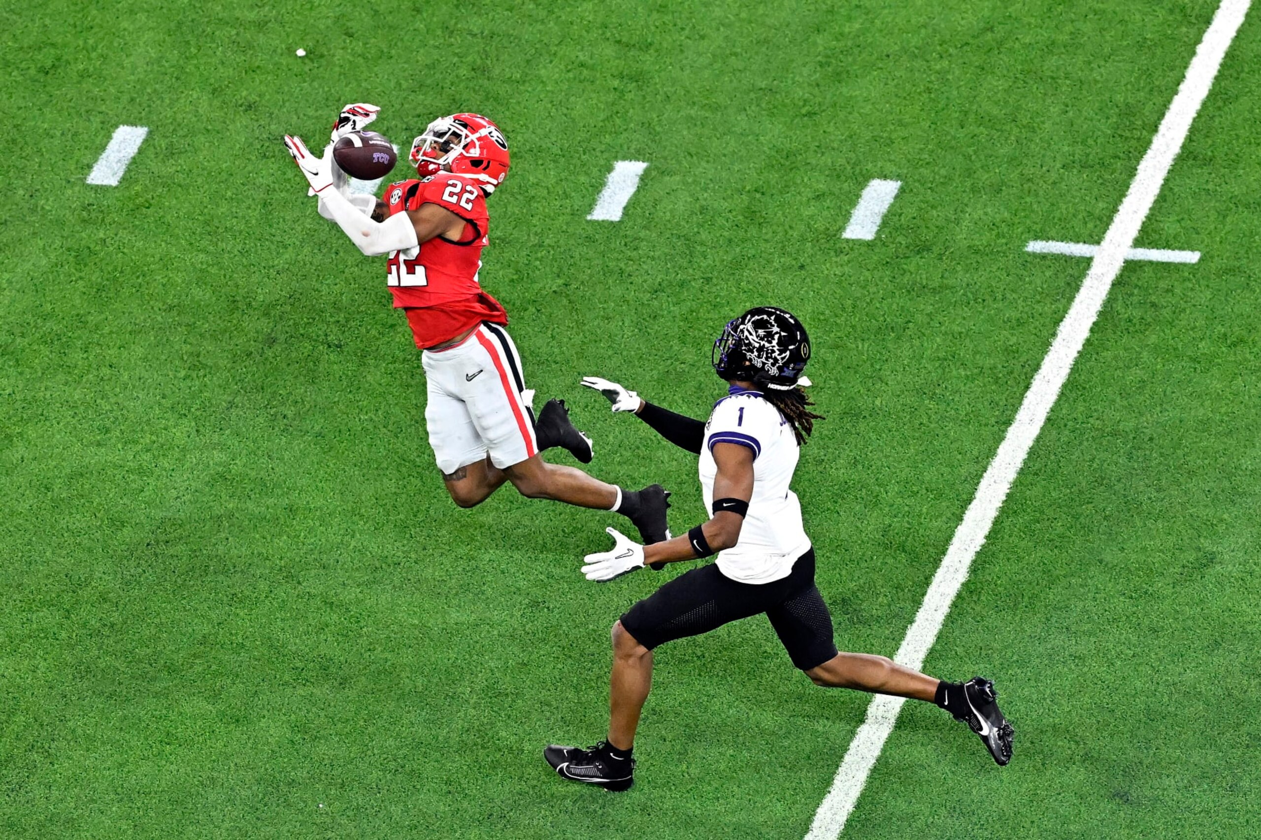 INGLEWOOD, CALIFORNIA - JANUARY 09: Javon Bullard #22 of the Georgia Bulldogs intercepts a pass intended for Quentin Johnston #1 of the TCU Horned Frogs in the second quarter in the College Football Playoff National Championship game at SoFi Stadium on January 09, 2023 in Inglewood, California. (Photo by Kevork Djansezian/Getty Images) INGLEWOOD, CALIFORNIA - JANUARY 09: Javon Bullard #22 of the Georgia Bulldogs intercepts a pass intended for Quentin Johnston #1 of the TCU Horned Frogs in the second quarter in the College Football Playoff National Championship game at SoFi Stadium on January 09, 2023 in Inglewood, California. (Photo by Kevork Djansezian/Getty Images)