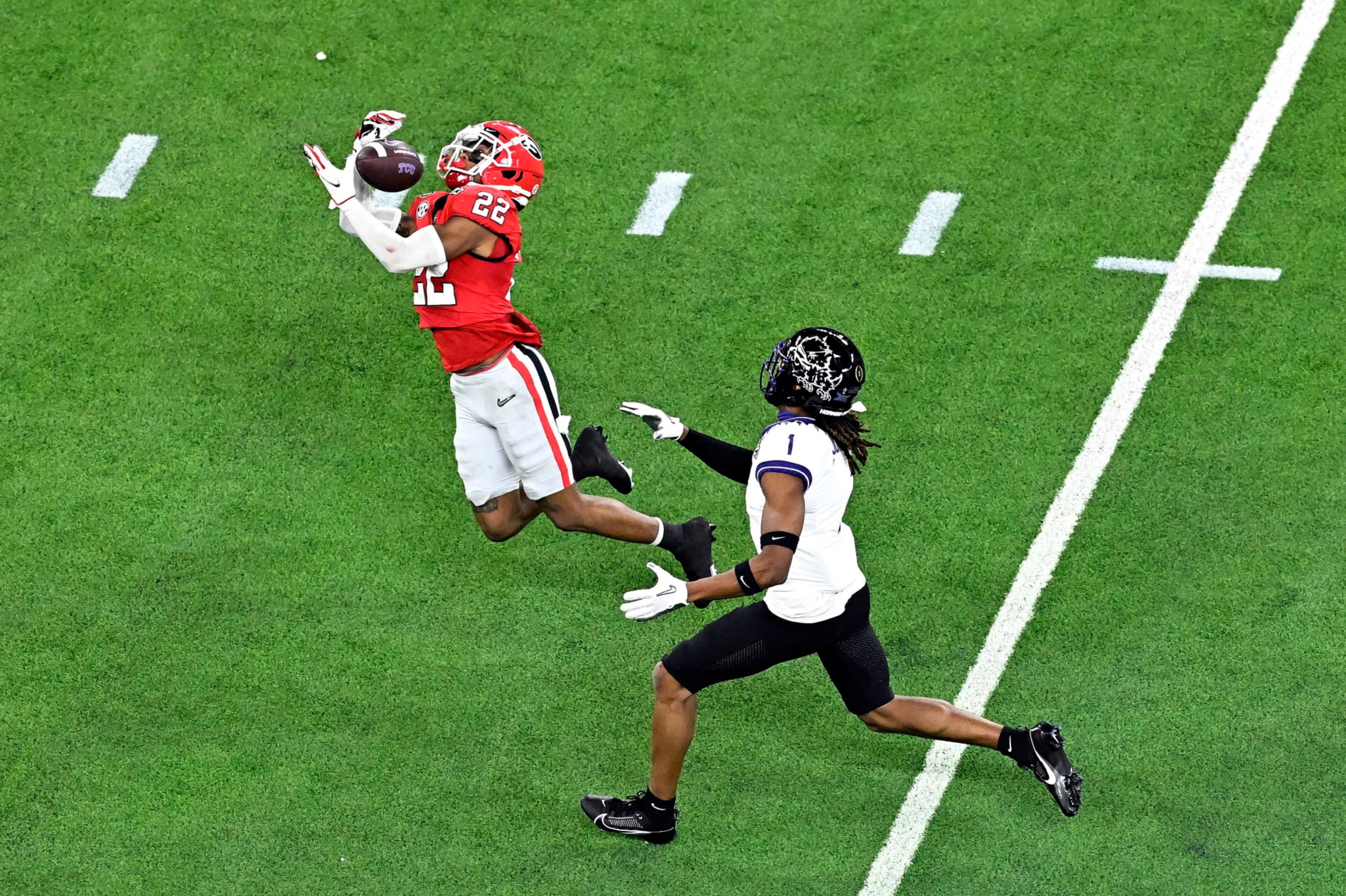 INGLEWOOD, CALIFORNIA - JANUARY 09: Javon Bullard #22 of the Georgia Bulldogs intercepts a pass intended for Quentin Johnston #1 of the TCU Horned Frogs in the second quarter in the College Football Playoff National Championship game at SoFi Stadium on January 09, 2023 in Inglewood, California. (Photo by Kevork Djansezian/Getty Images)