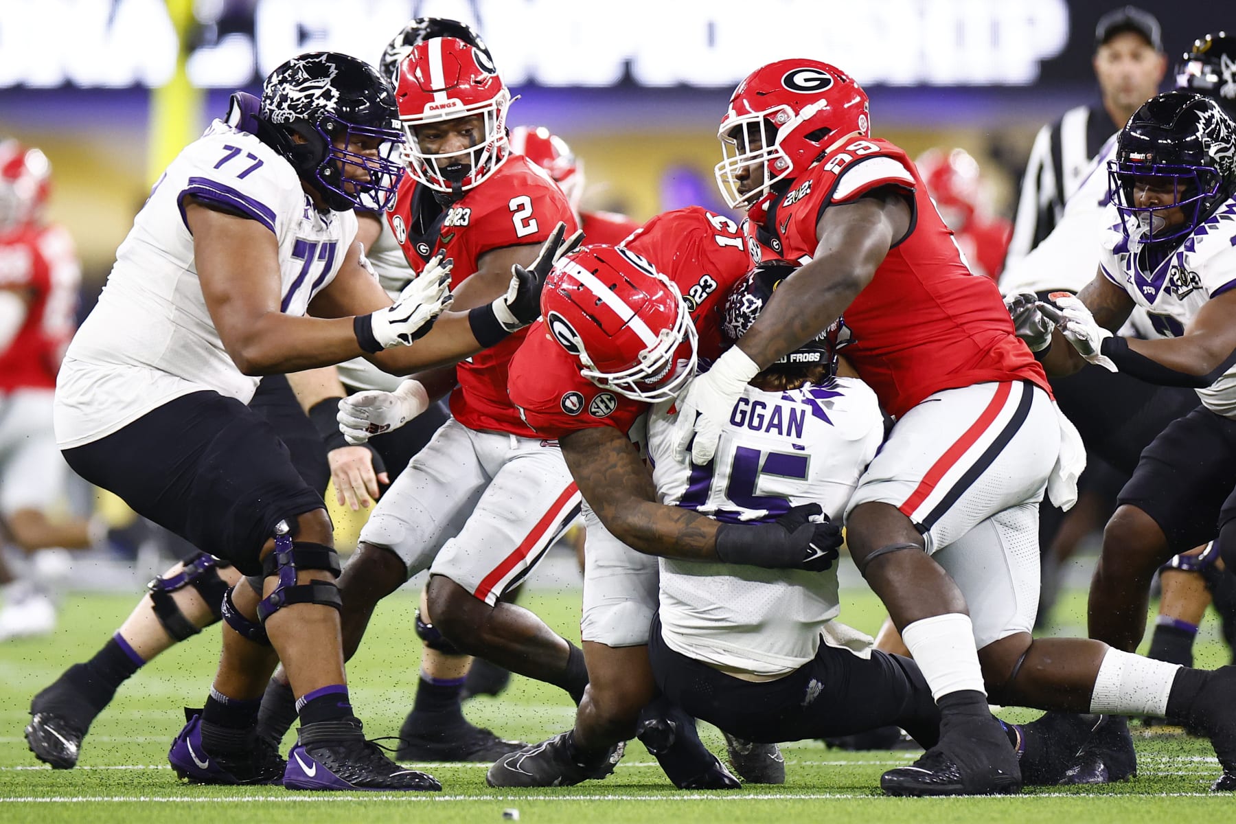 INGLEWOOD, CALIFORNIA - JANUARY 09: Max Duggan #15 of the TCU Horned Frogs is sacked by Trezmen Marshall #15 and Braxton Hicks #89 of the Georgia Bulldogs during the first quarter  in the College Football Playoff National Championship game at SoFi Stadium on January 09, 2023 in Inglewood, California. (Photo by Ronald Martinez/Getty Images)