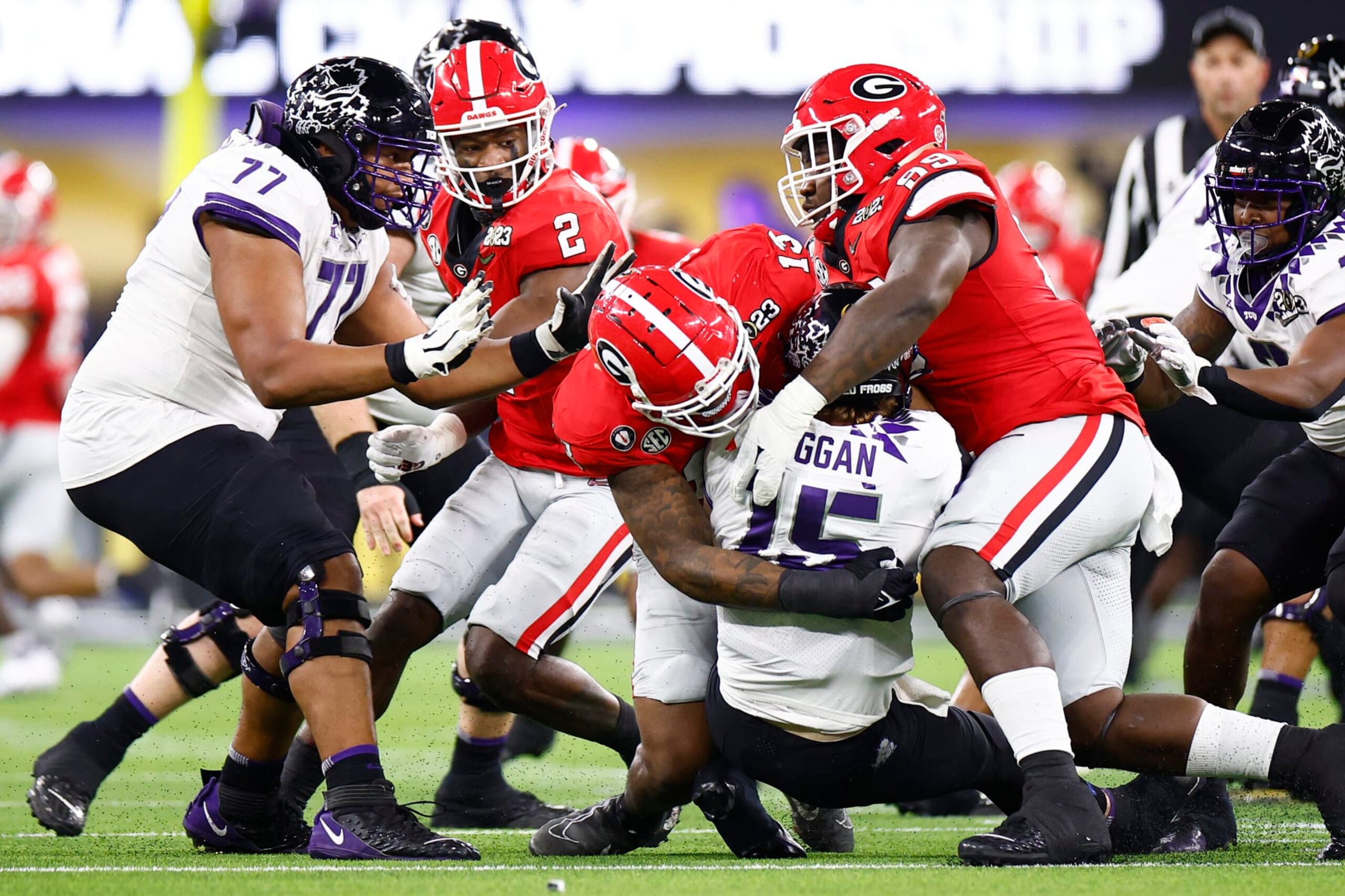 INGLEWOOD, CALIFORNIA - JANUARY 09: Max Duggan #15 of the TCU Horned Frogs is sacked by Trezmen Marshall #15 and Braxton Hicks #89 of the Georgia Bulldogs during the first quarter in the College Football Playoff National Championship game at SoFi Stadium on January 09, 2023 in Inglewood, California. (Photo by Ronald Martinez/Getty Images) INGLEWOOD, CALIFORNIA - JANUARY 09: Max Duggan #15 of the TCU Horned Frogs is sacked by Trezmen Marshall #15 and Braxton Hicks #89 of the Georgia Bulldogs during the first quarter in the College Football Playoff National Championship game at SoFi Stadium on January 09, 2023 in Inglewood, California. (Photo by Ronald Martinez/Getty Images)
