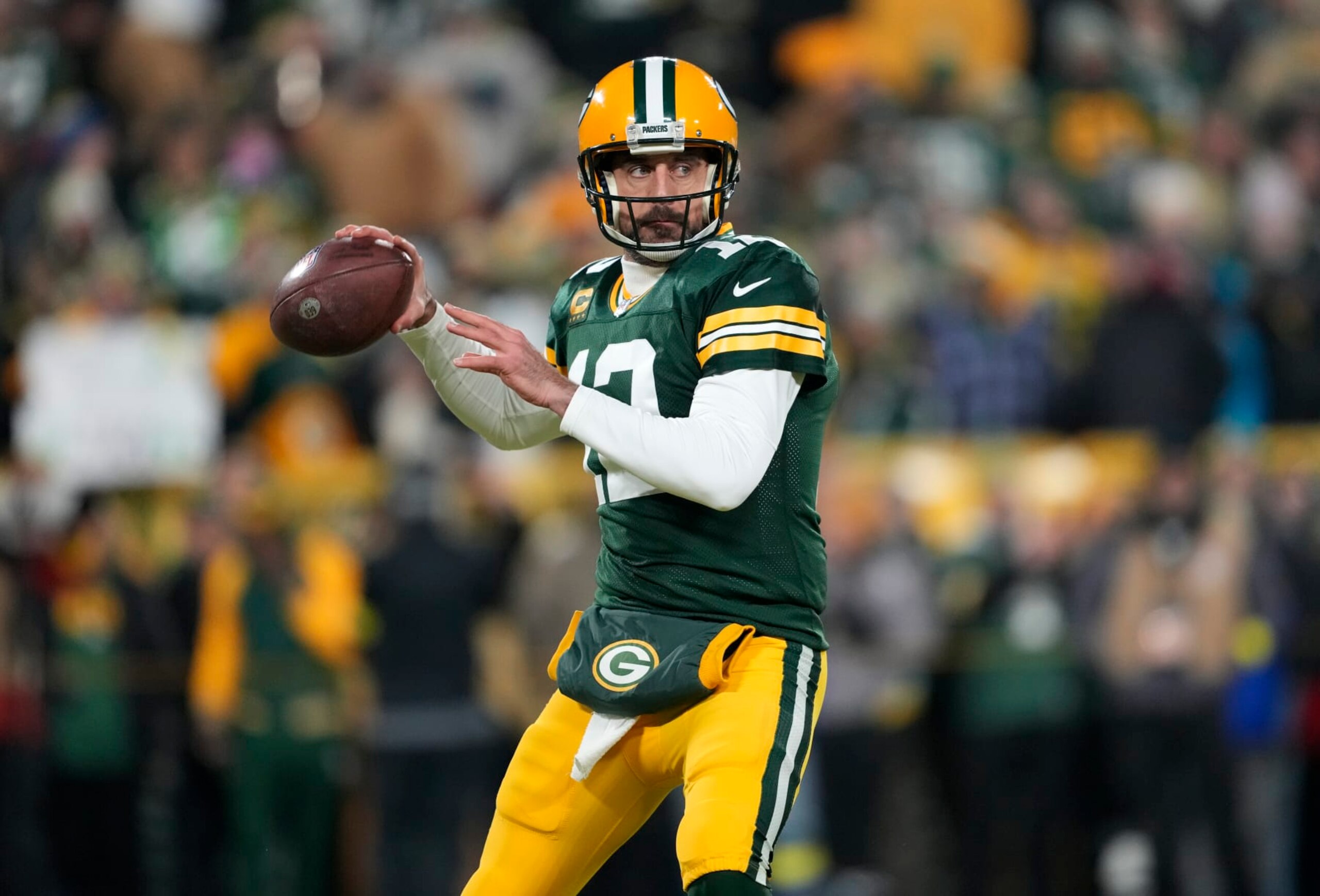 GREEN BAY, WISCONSIN - JANUARY 08: Aaron Rodgers #12 of the Green Bay Packers warms up prior to the game against the Detroit Lions at Lambeau Field on January 08, 2023 in Green Bay, Wisconsin. (Photo by Patrick McDermott/Getty Images)